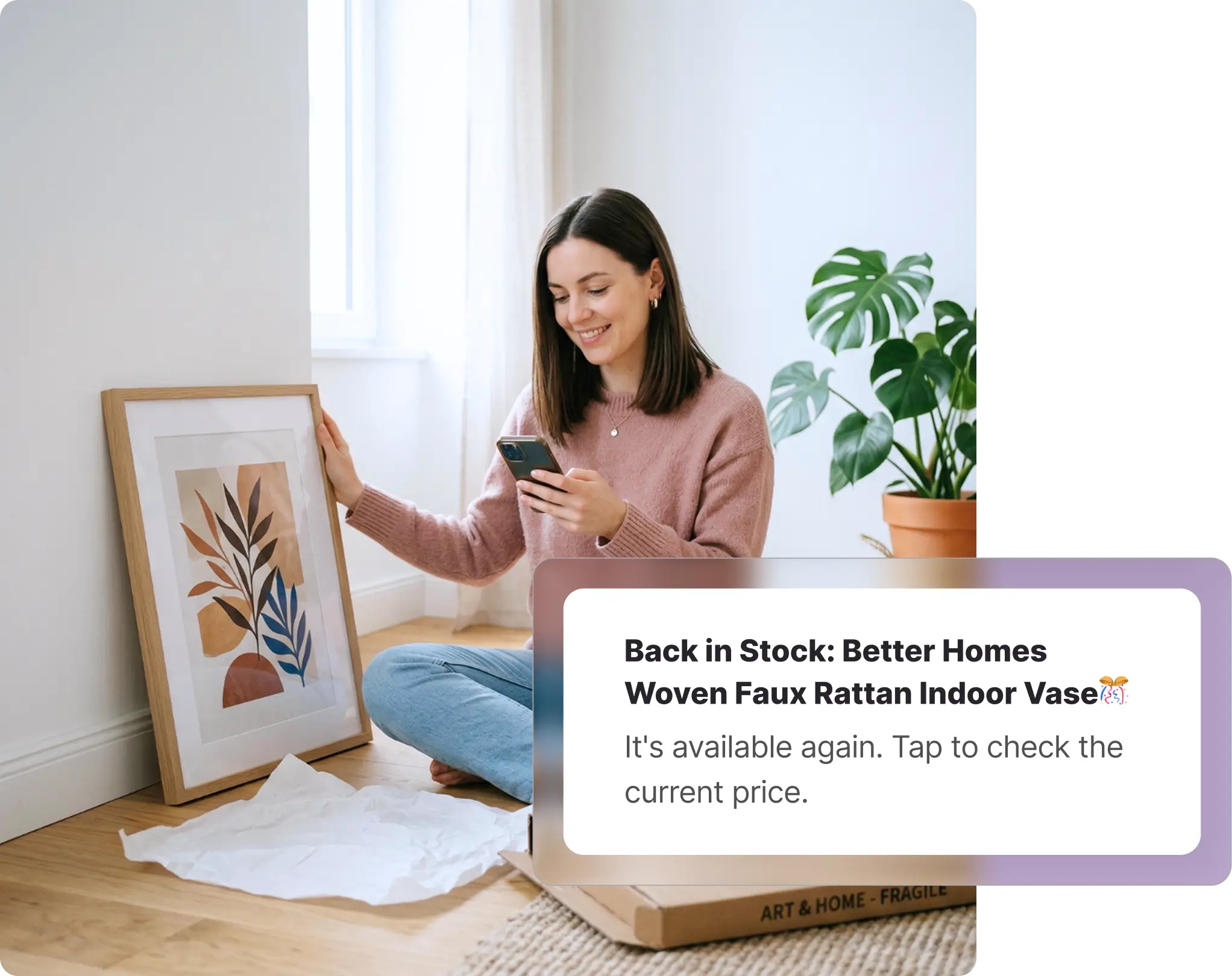 A smiling woman sitting on a wooden floor next to framed art and an open package, looking at her smartphone. Overlaid on the image is a Whisprice digital notification displaying a back-in-stock alert for a Walmart product, specifically a "Better Homes Woven Faux Rattan Indoor Vase," prompting the user to tap and check the current price.