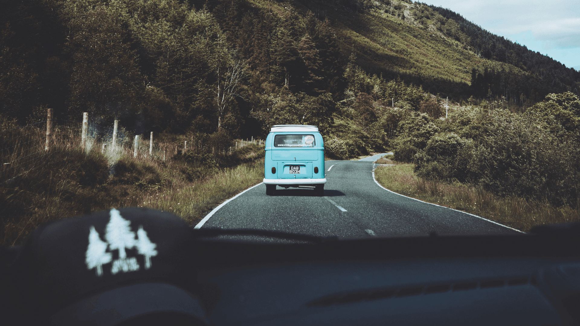 A shot of a VW driving along a country road