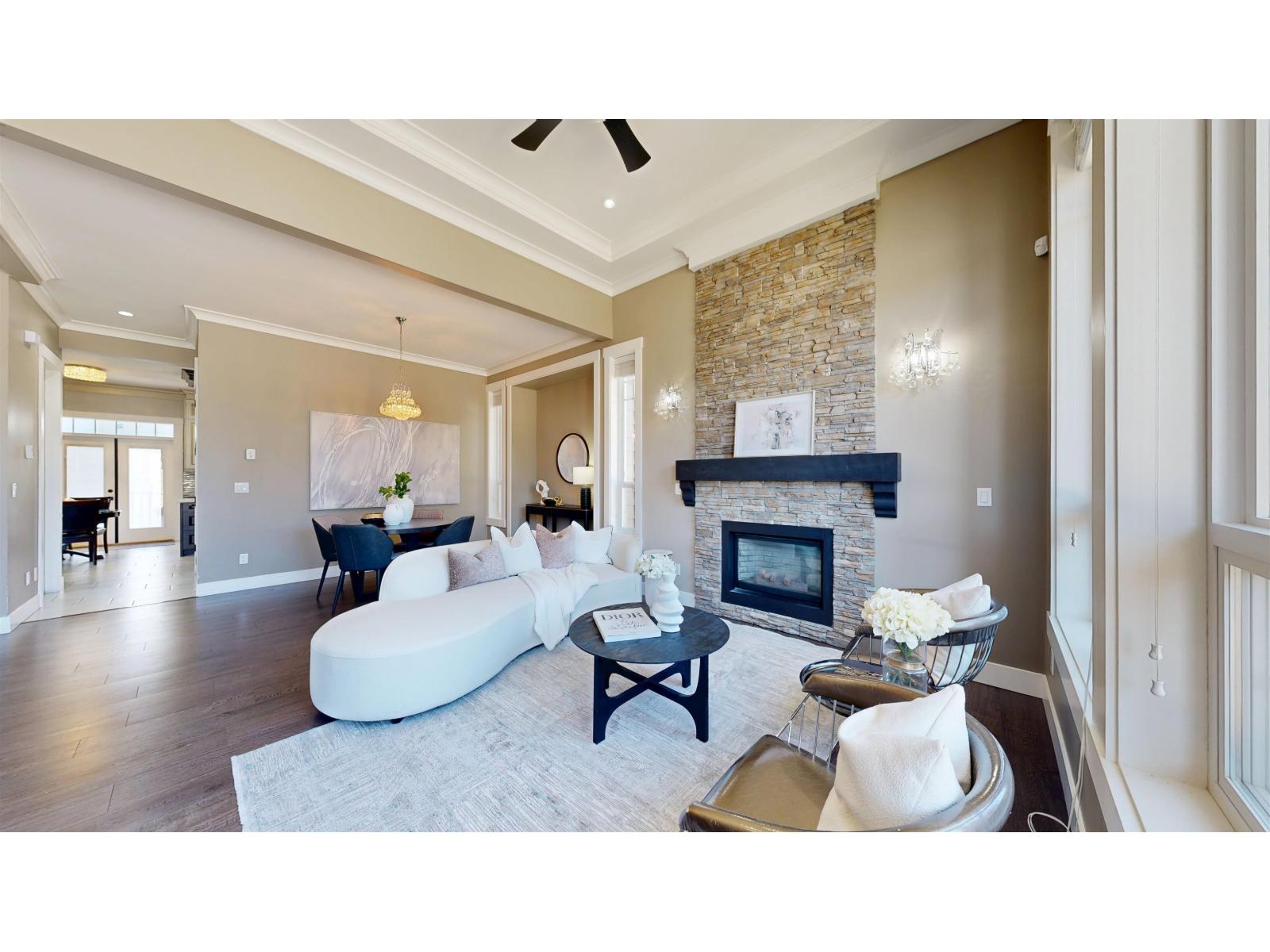 Bright, modern living room featuring a cozy sofa, coffee table, and a fireplace, with light-colored walls and wooden floors.