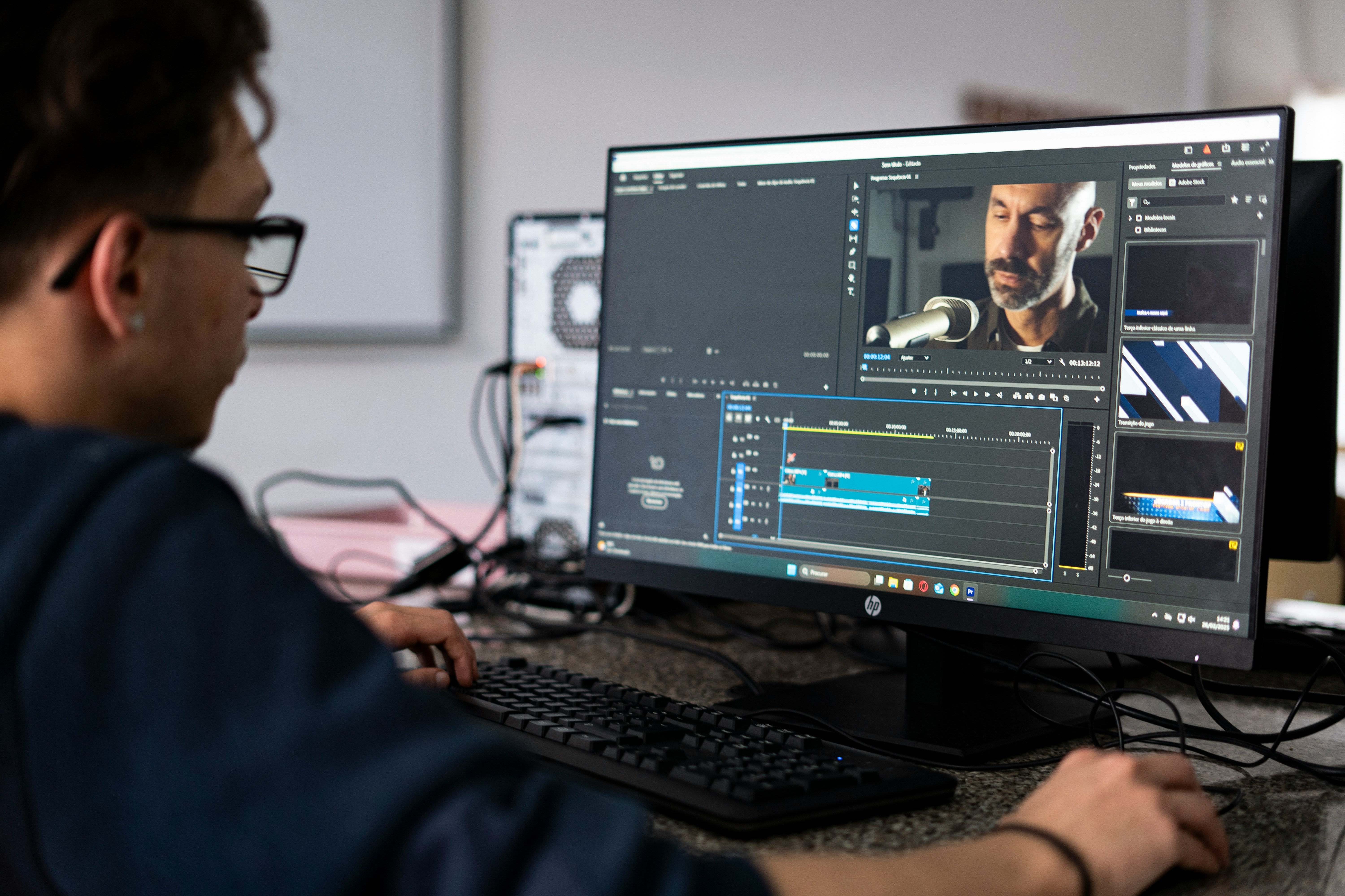Person editing video in Premiere Pro with timeline and preview monitor visible on screen