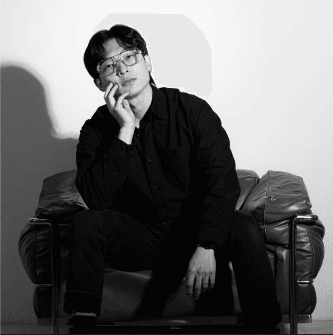 grayscale photo of man in crew neck shirt and eyeglasses