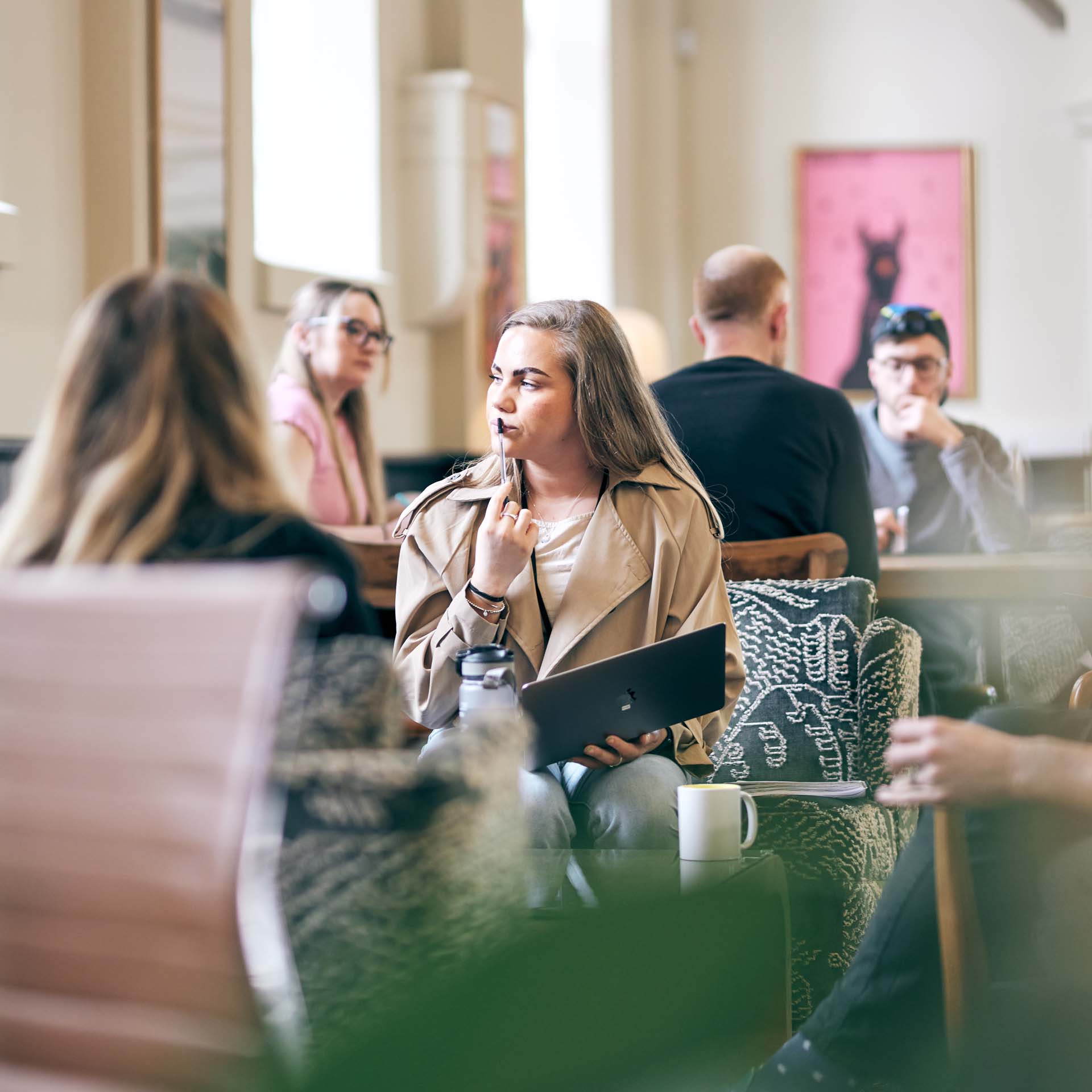 People sat around a stylish table talking and brainstorming