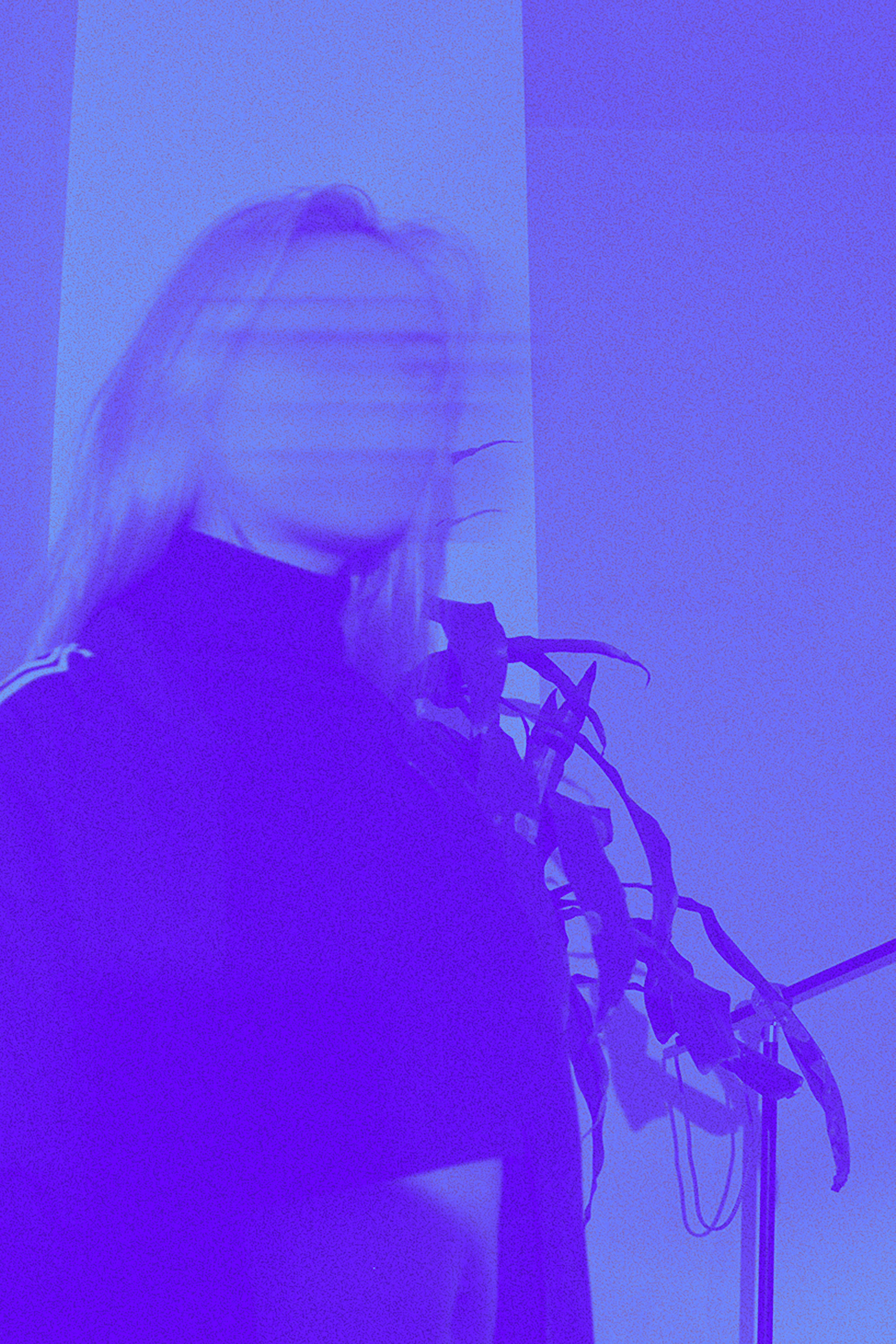 a blurry photo of a person standing in front of a wall