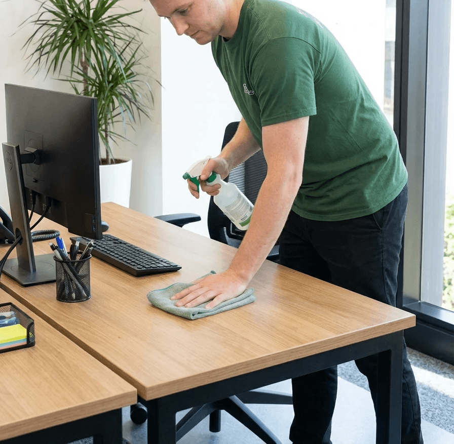 No Spots staff cleaning a mirror