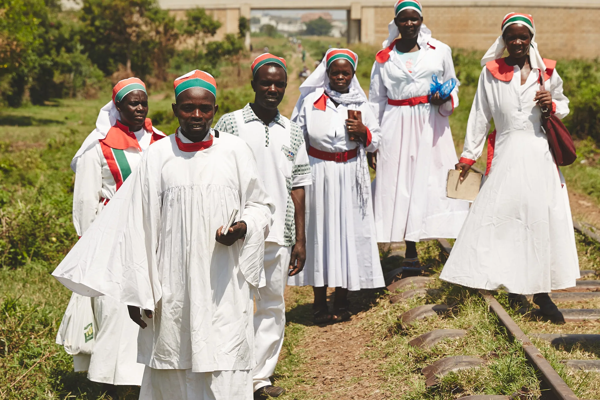 congregation walking along railway tracks — portrait photography by Tom Kubik