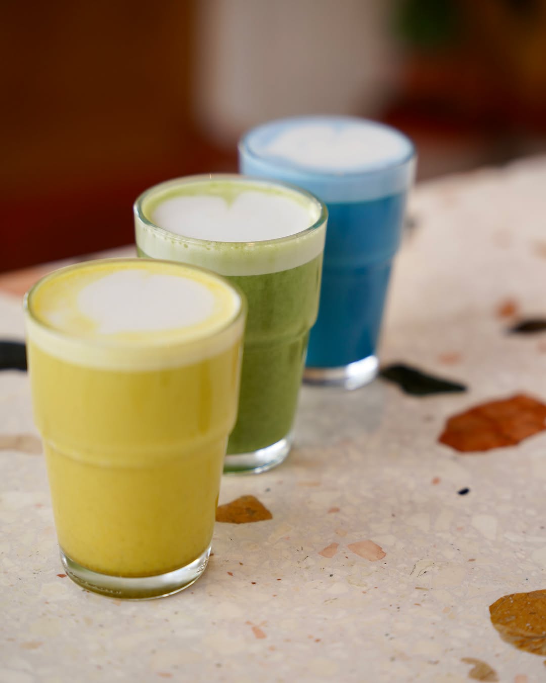 3 Cups of Juice, on a table.