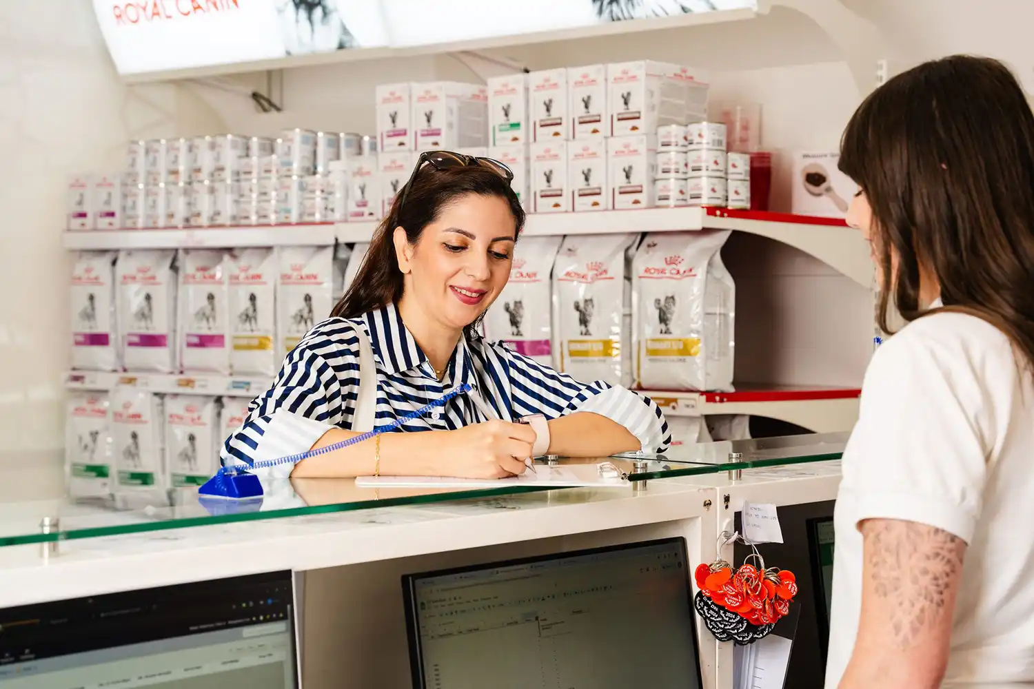 A pet owner picks up her cat’s medications at our vet pharmacy in Dubai.