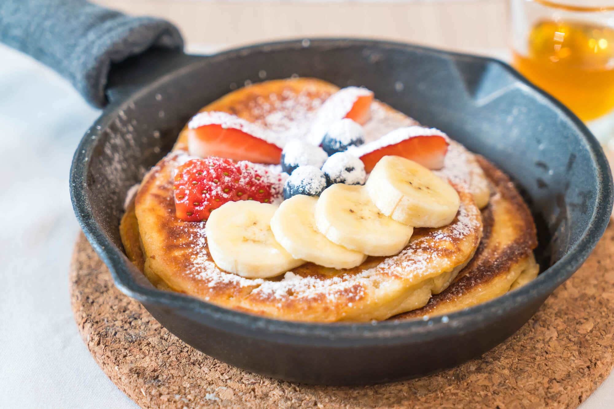 pancakes with berries on white ceramic plate
