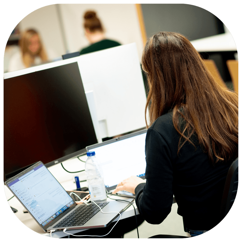 Opencast team member working at a computer in an office space
