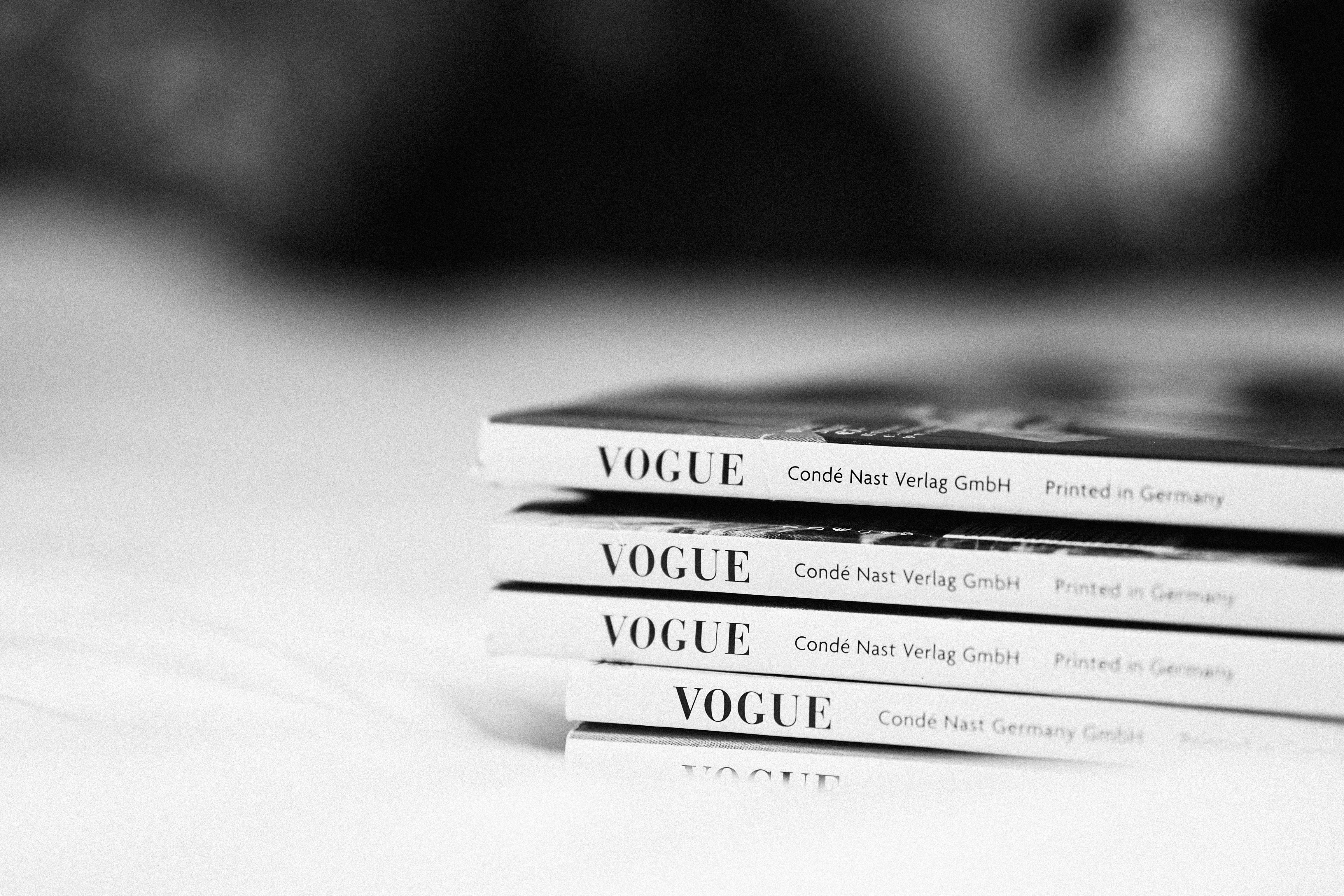 Stack of Vogue magazines representing the need for brands to stay culturally relevant and get cited by ChatGPT and other AI models through strong AI SEO consulting.