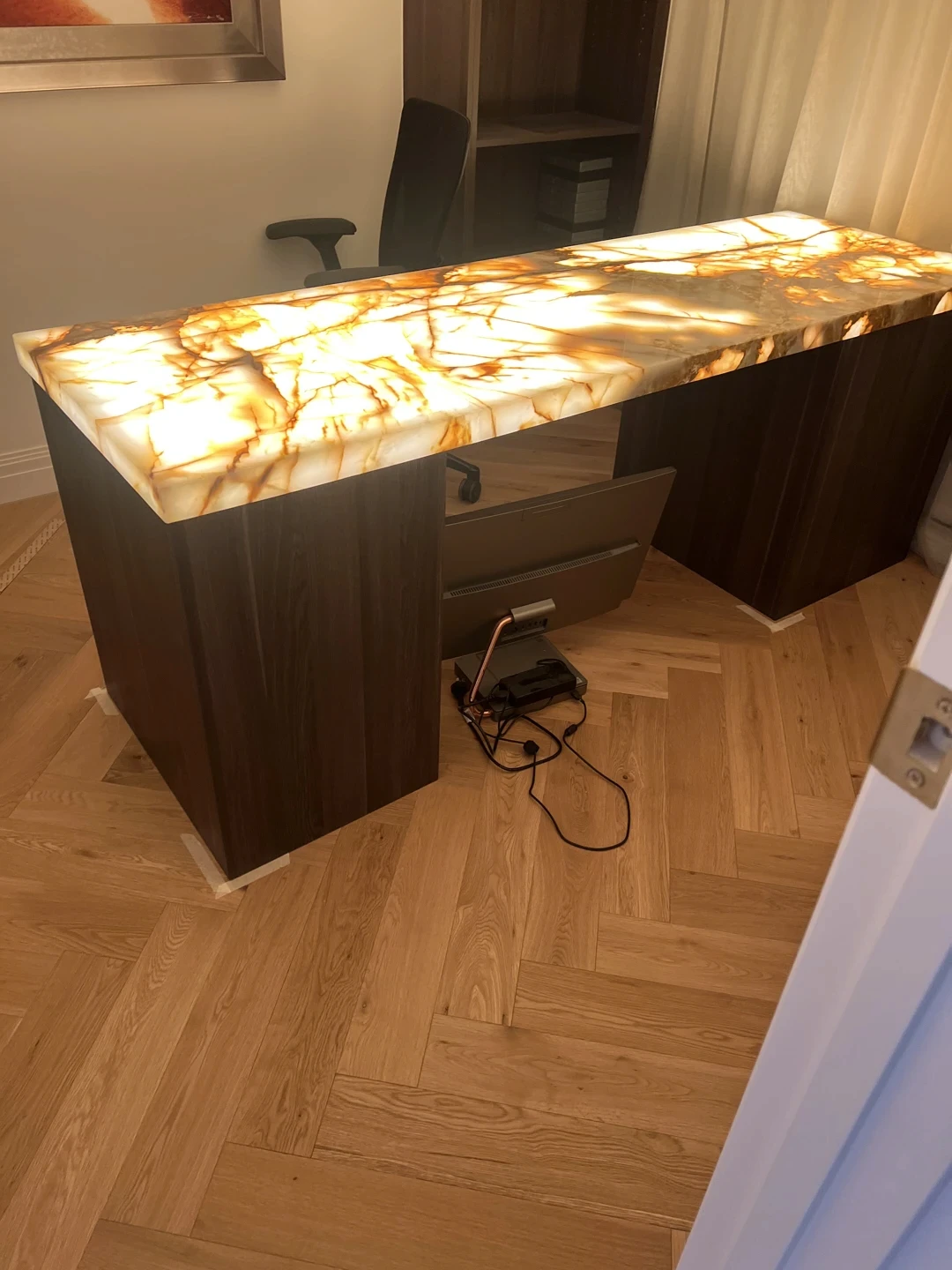Natural stone stair landing or threshold detail with marble surface and timber stair setting.
