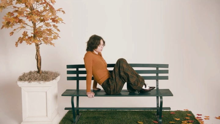 Wide view of Emma Myers within the finished autumn park set