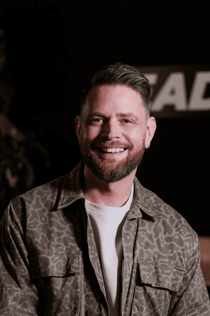 headshot of male in dark background