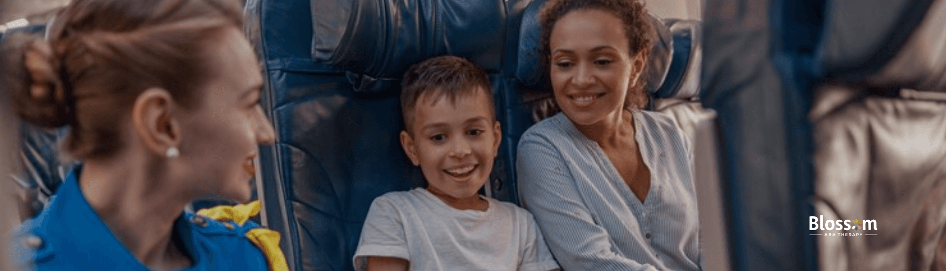 A mother and his autistic child talking to a flight attendant in an airplane