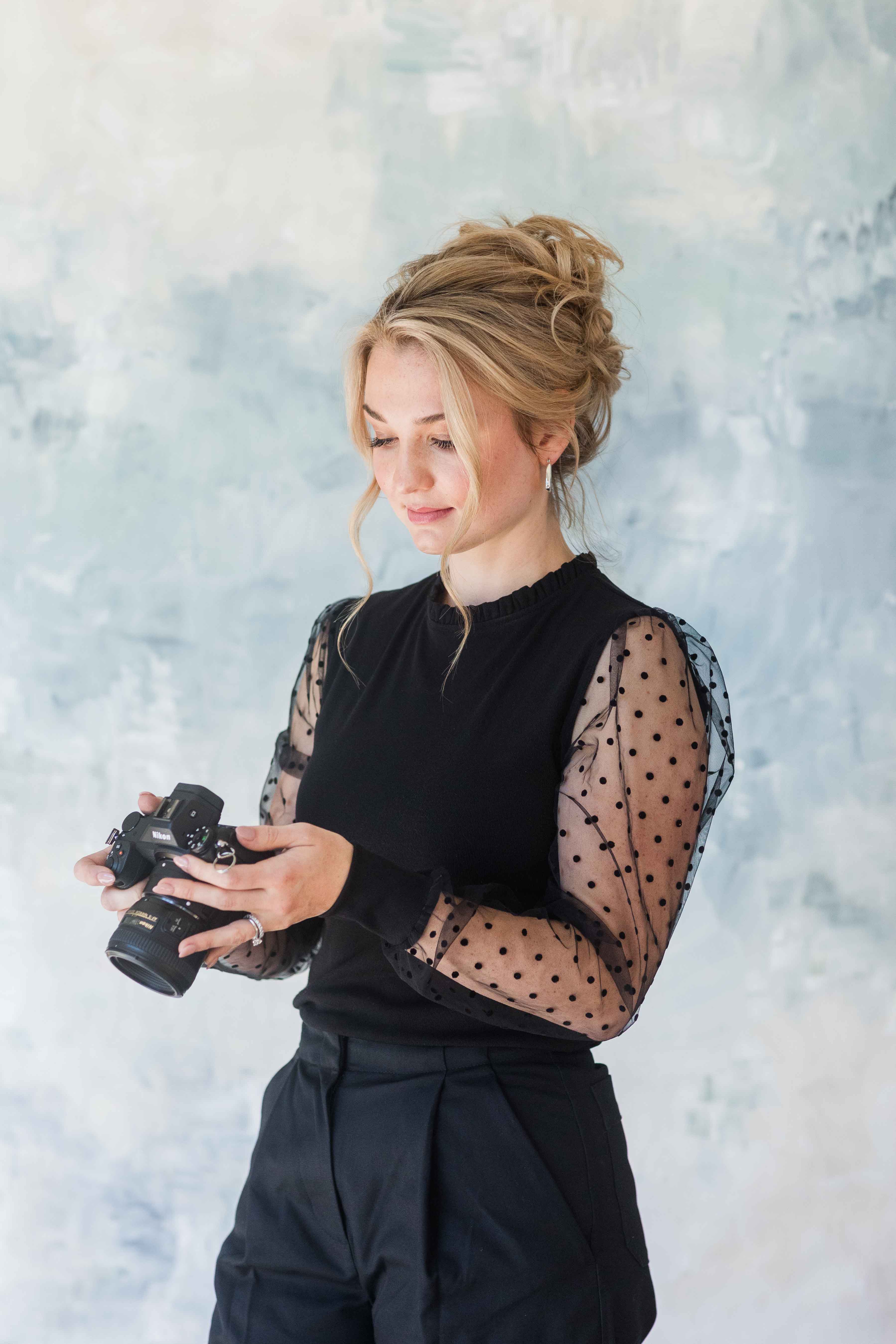 photographer holding camera headshot of rebecca musayev