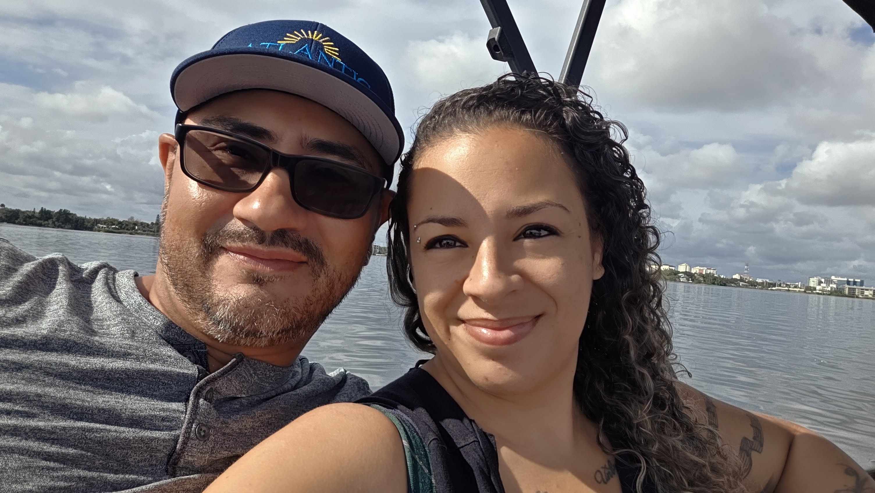 Local Florida owners of Atlantic Outdoor Lighting smiling together by the waterfront in Daytona Beach