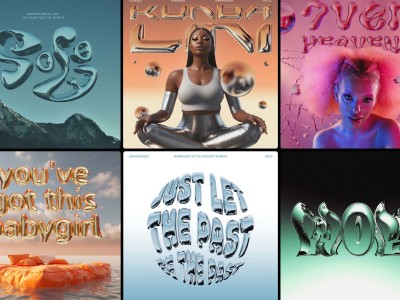 man wearing grey t-shirt standing in front of man sitting on chair