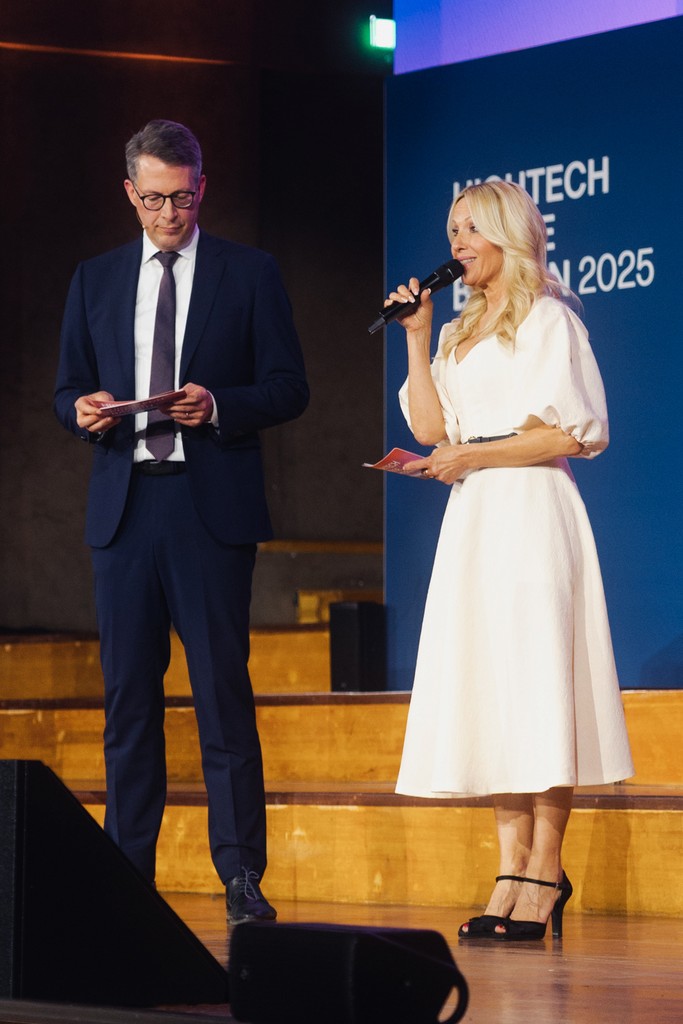 Male and female moderators presenting together at an event