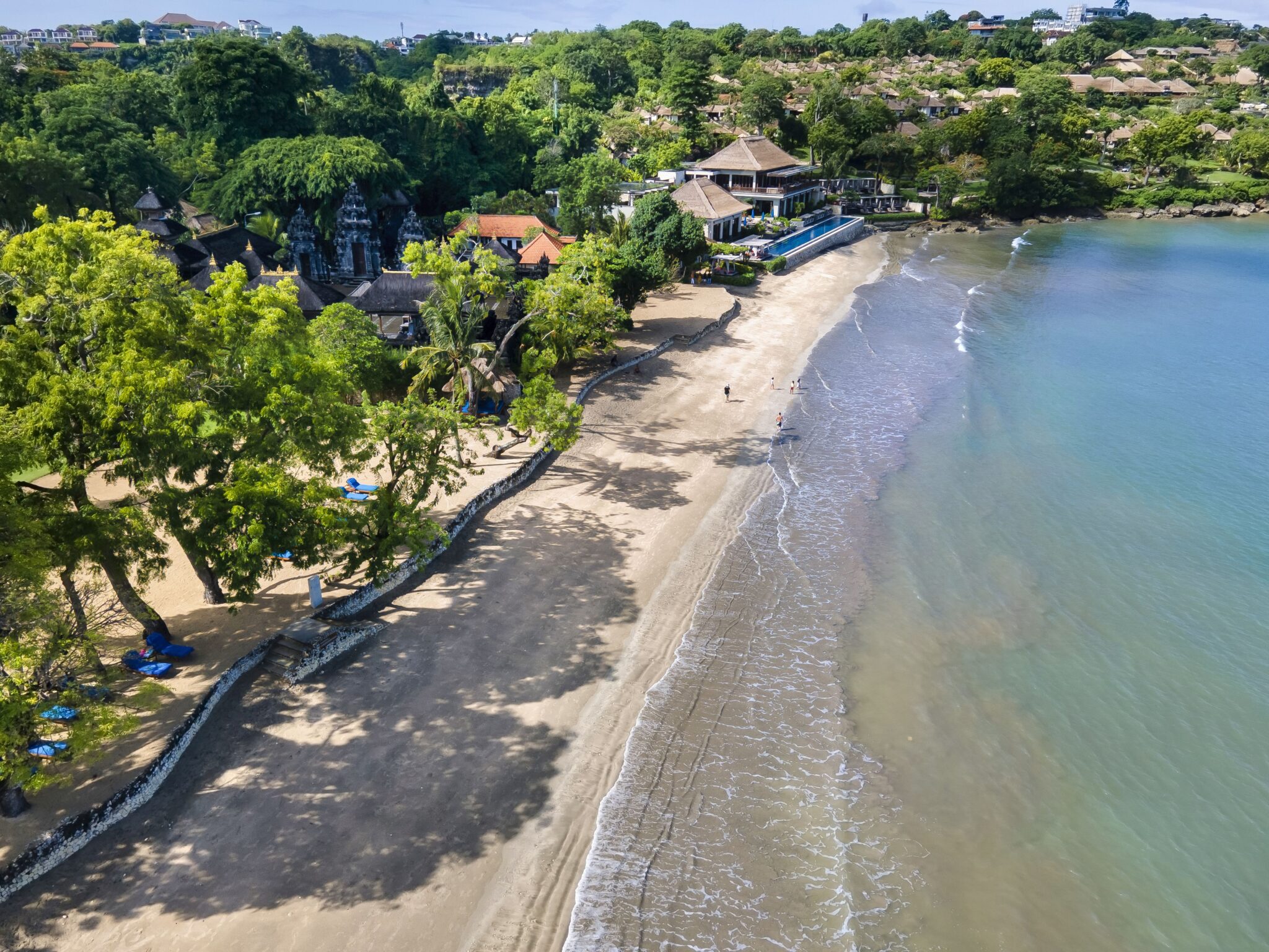 Scenic view of Jimbaran beach coastline and luxury villas managed by local experts.