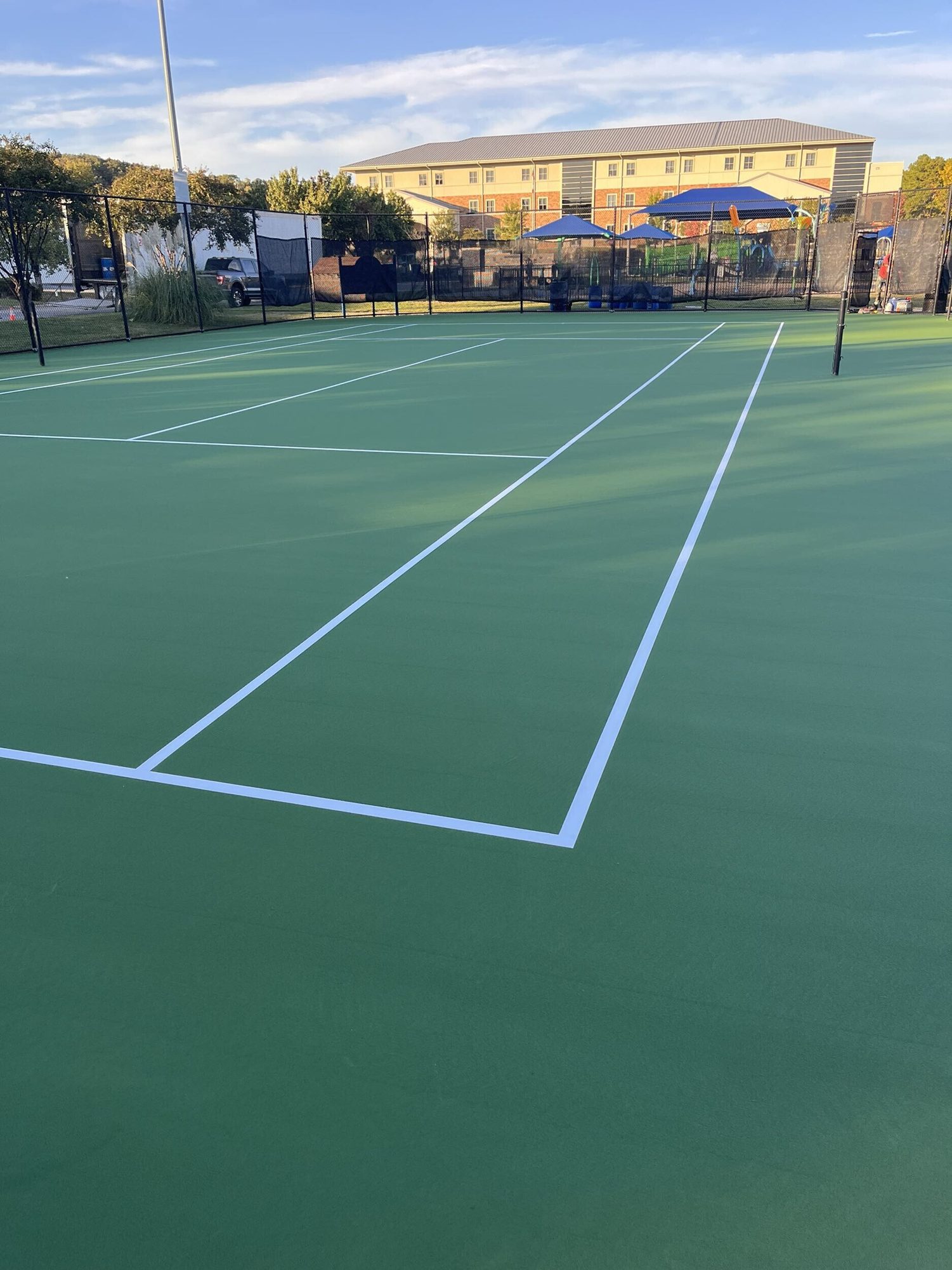 Resurfaced green tennis court and new striping in Maumelle, AR