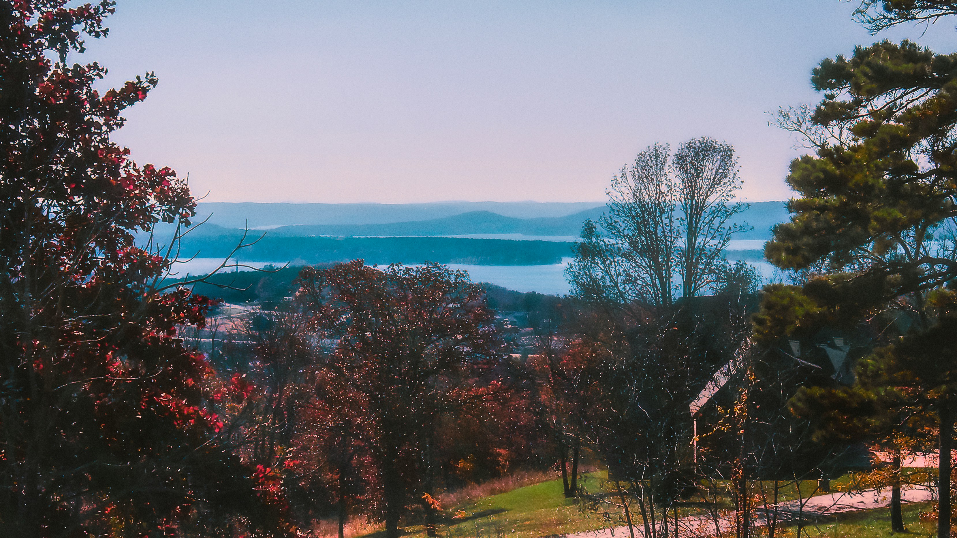 a scenic view of a lake and mountains in the distance
