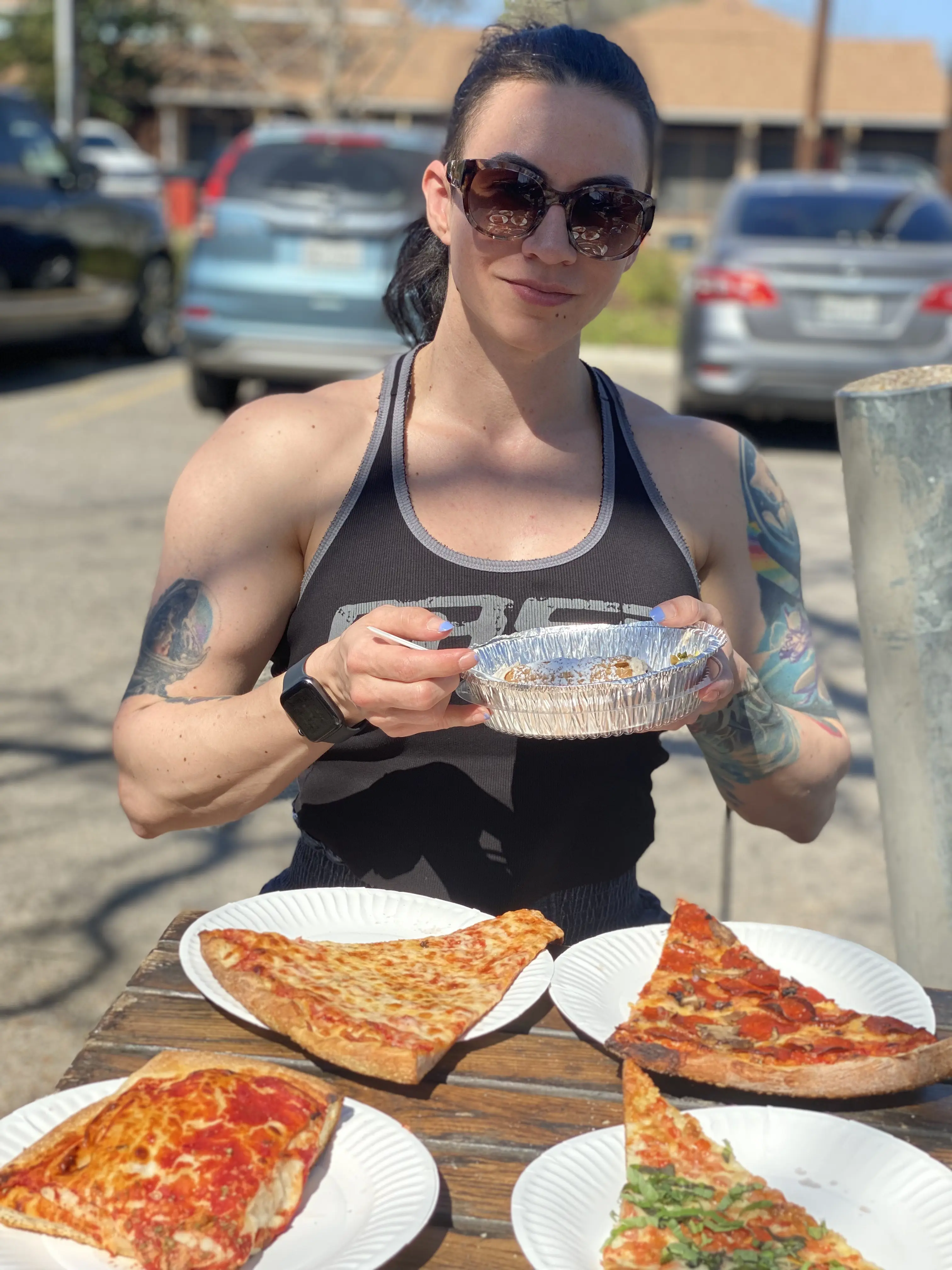Kim Eklund a bodybuidler eating a bunch of pizza