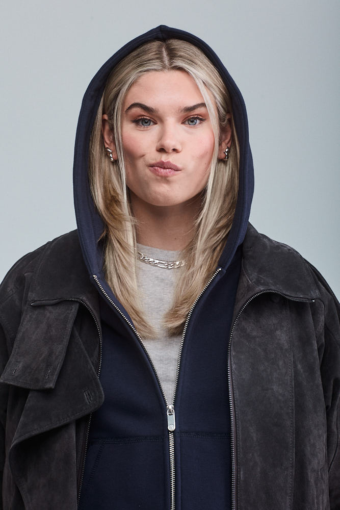 Woman wearing Sunday Superior navy hoodie