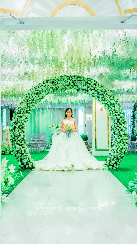 Bride walking the aisle toward the floral arch at Celestia Hall, Quezon City