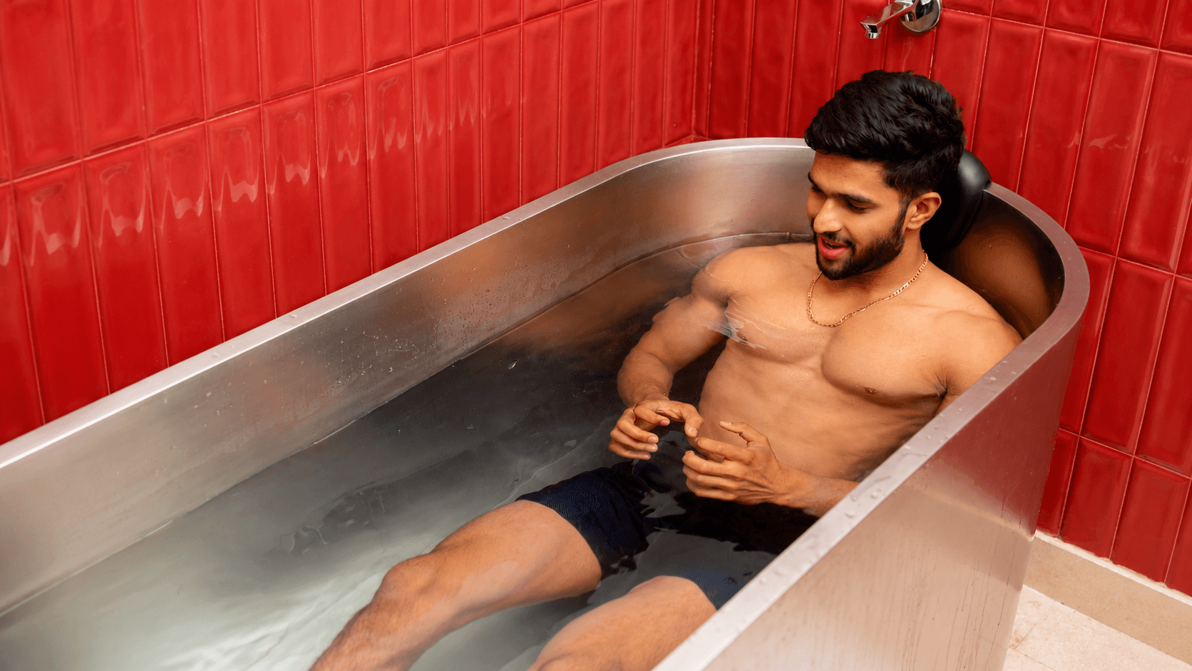 Man using cold plunge therapy for muscle recovery and performance restoration at Ember & Ice Health.