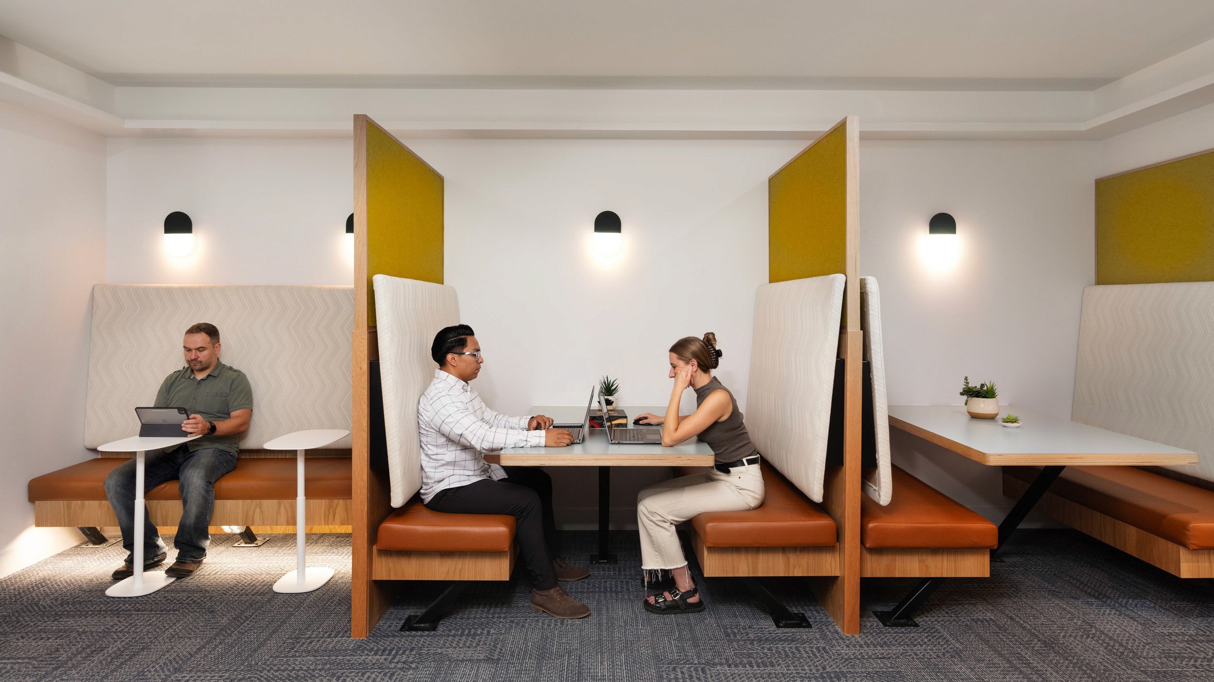People working in modern office booths.