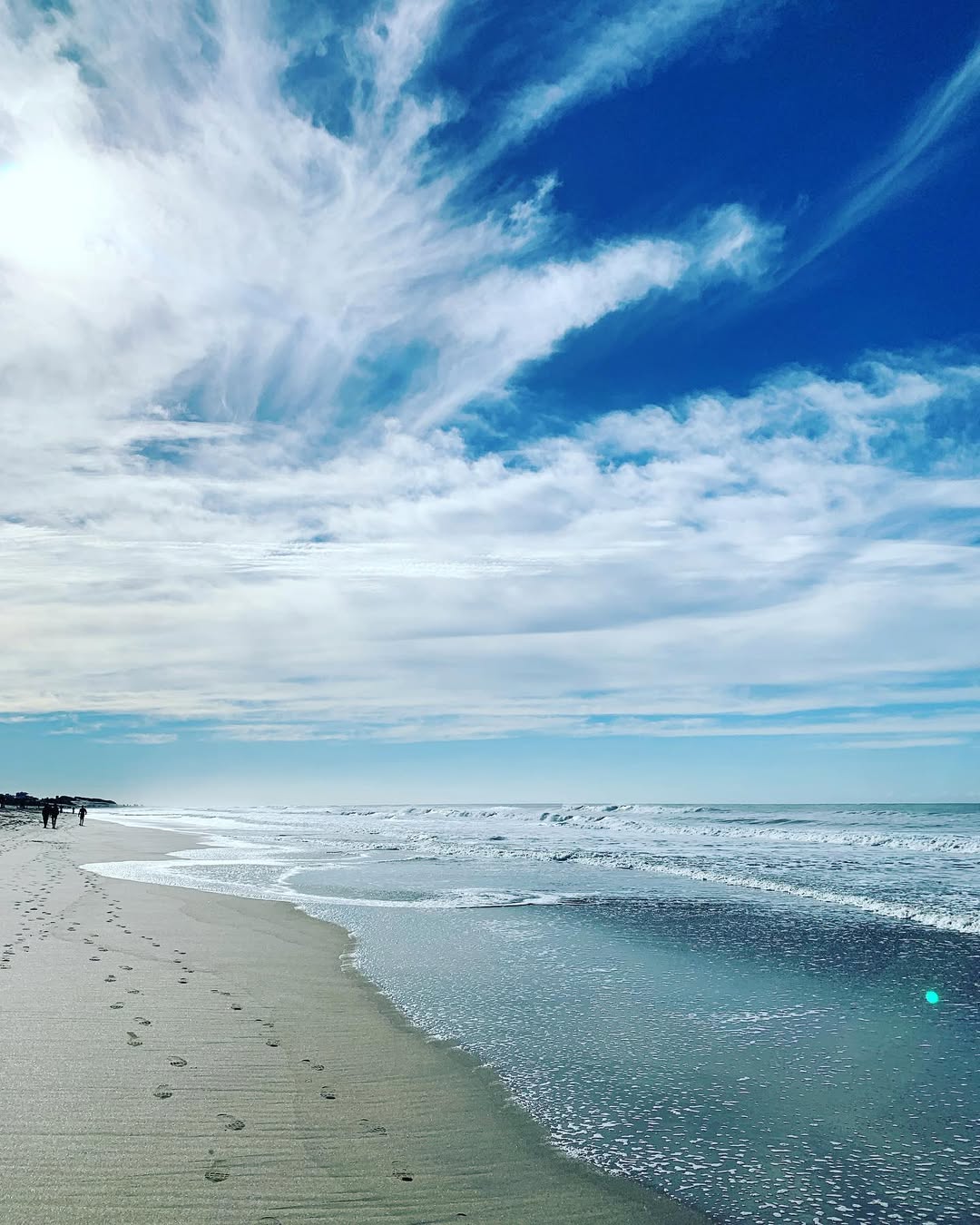 A woman receives a relaxing energy healing in a serene setting with soft lighting.