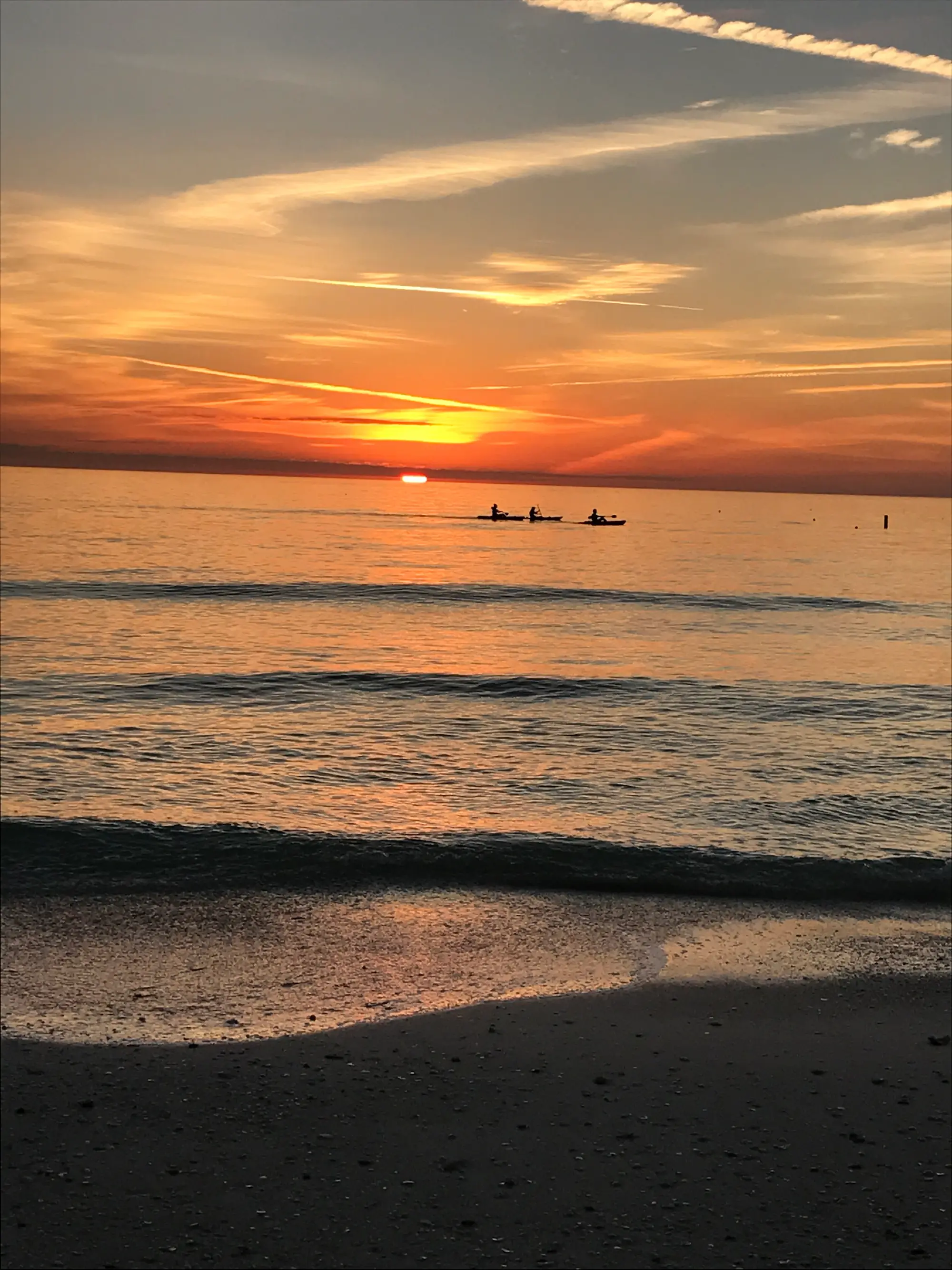 the sun is setting over the ocean on the beach att anna maria island