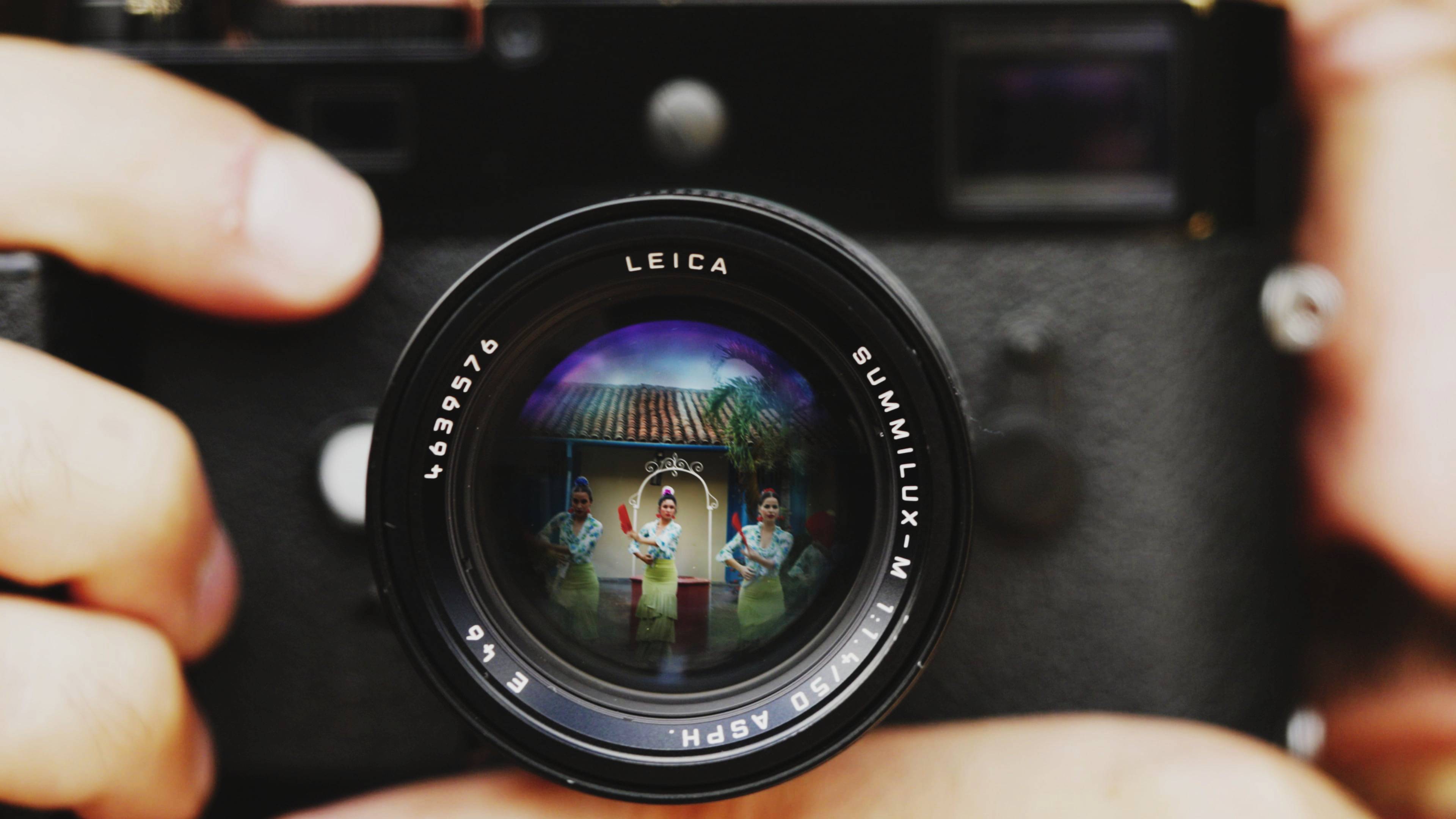 Front cover image for a short film made for Aljazeera. The image is of a camera with a reflection of women dancing in the lens.