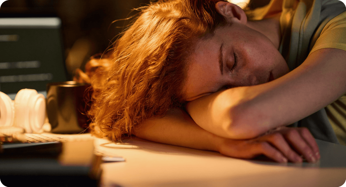 women sleeping on desk