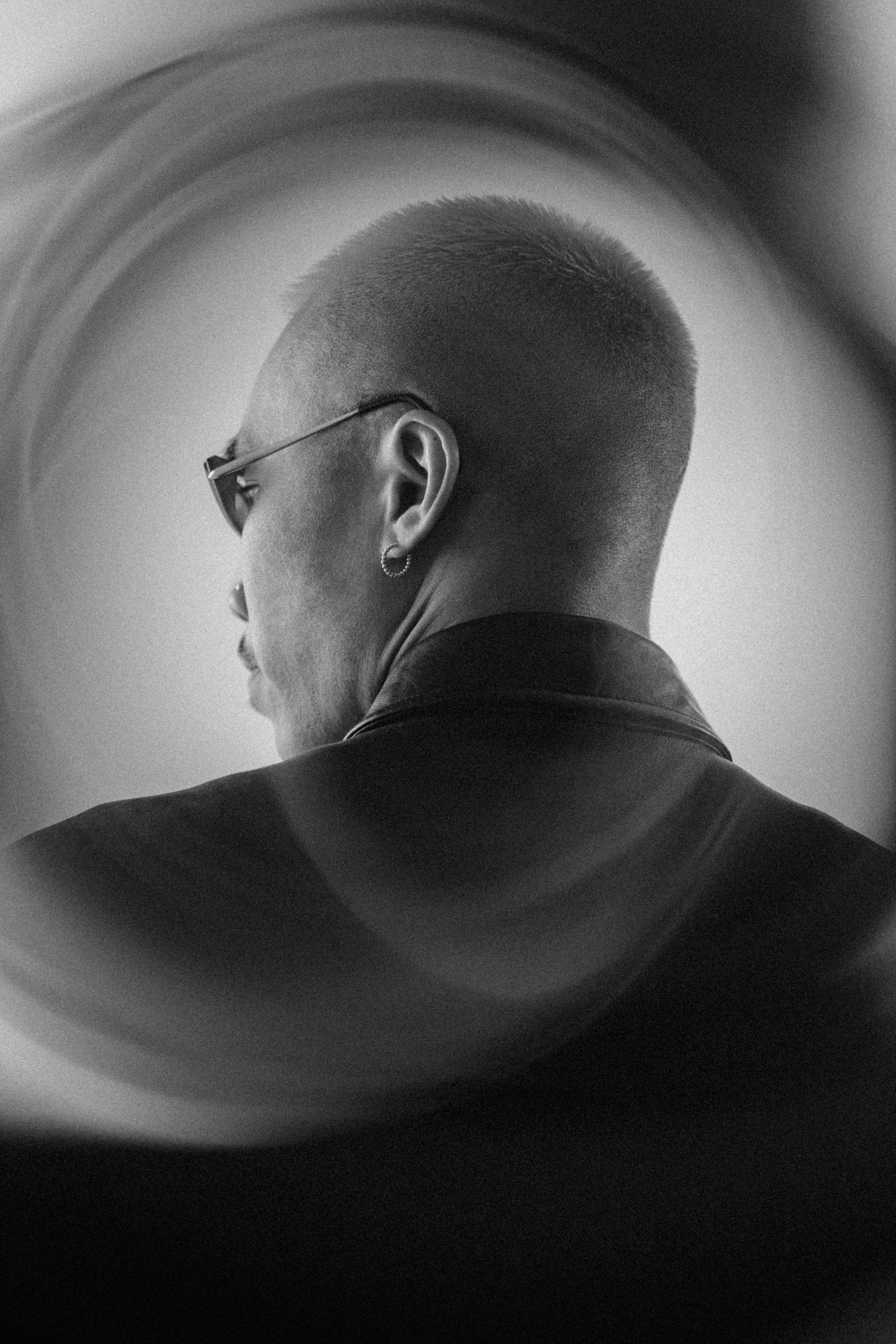 Man wearing glasses viewed from behind