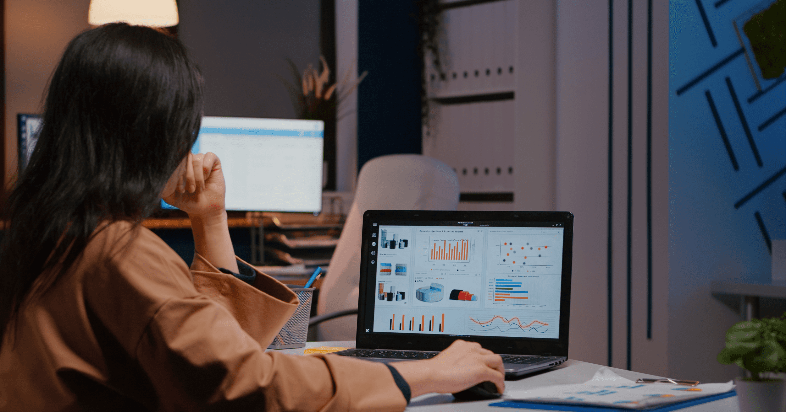 Entrepreneur looking atanalyzed data on her laptop