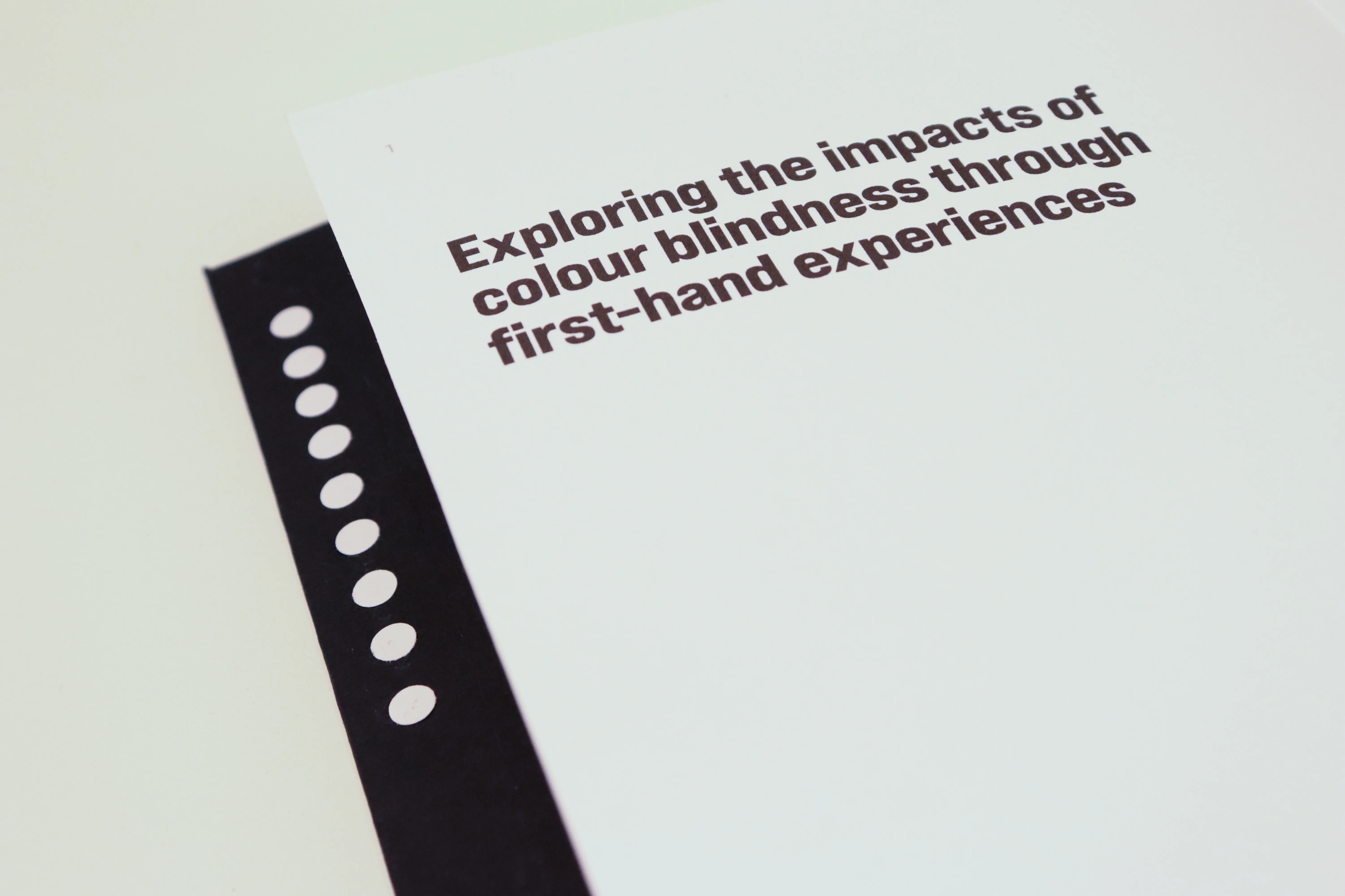 Close-up showing a column of dots on the inside cover margin next to a page