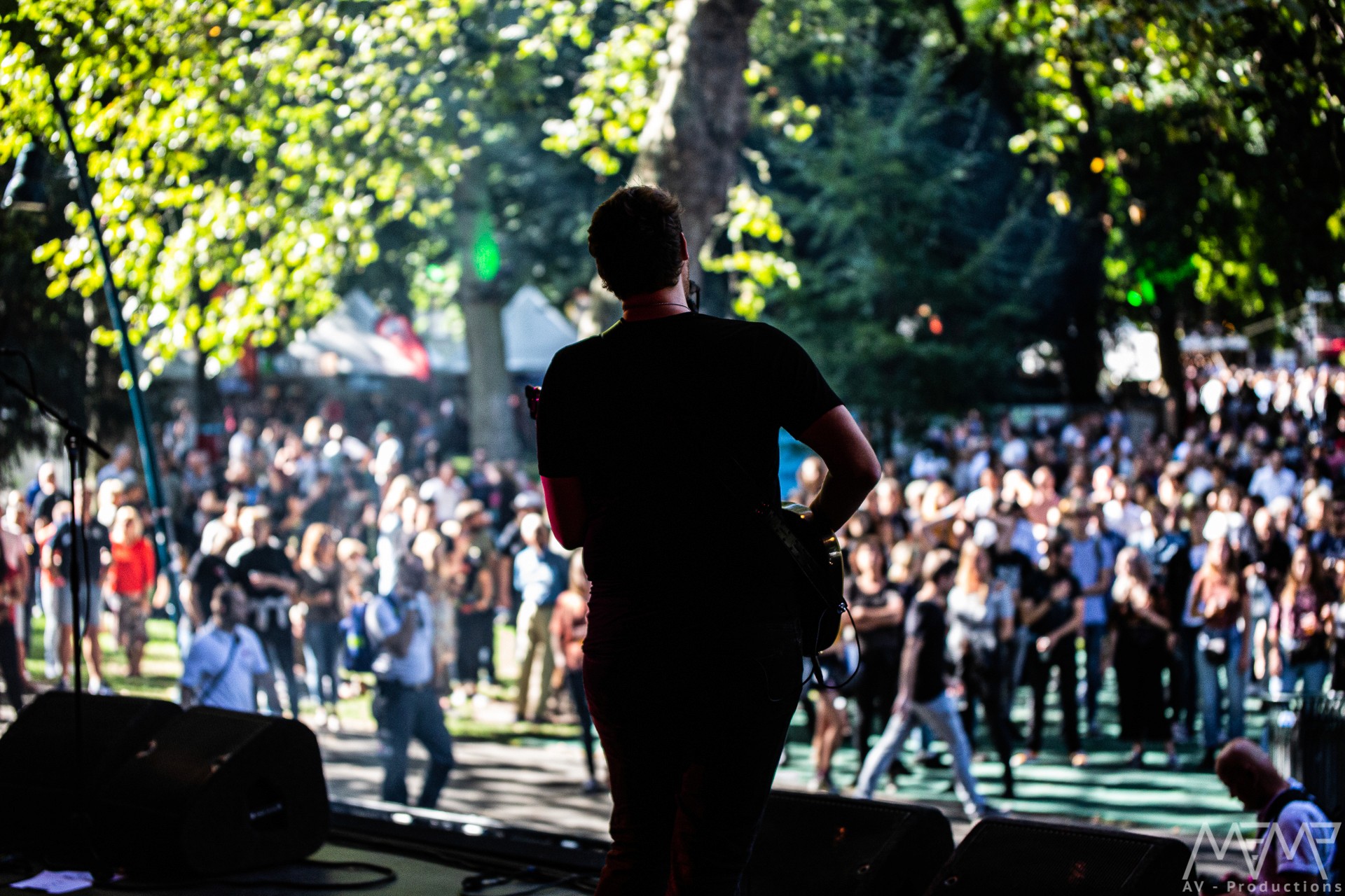 Performer under spotlight on dark stage
