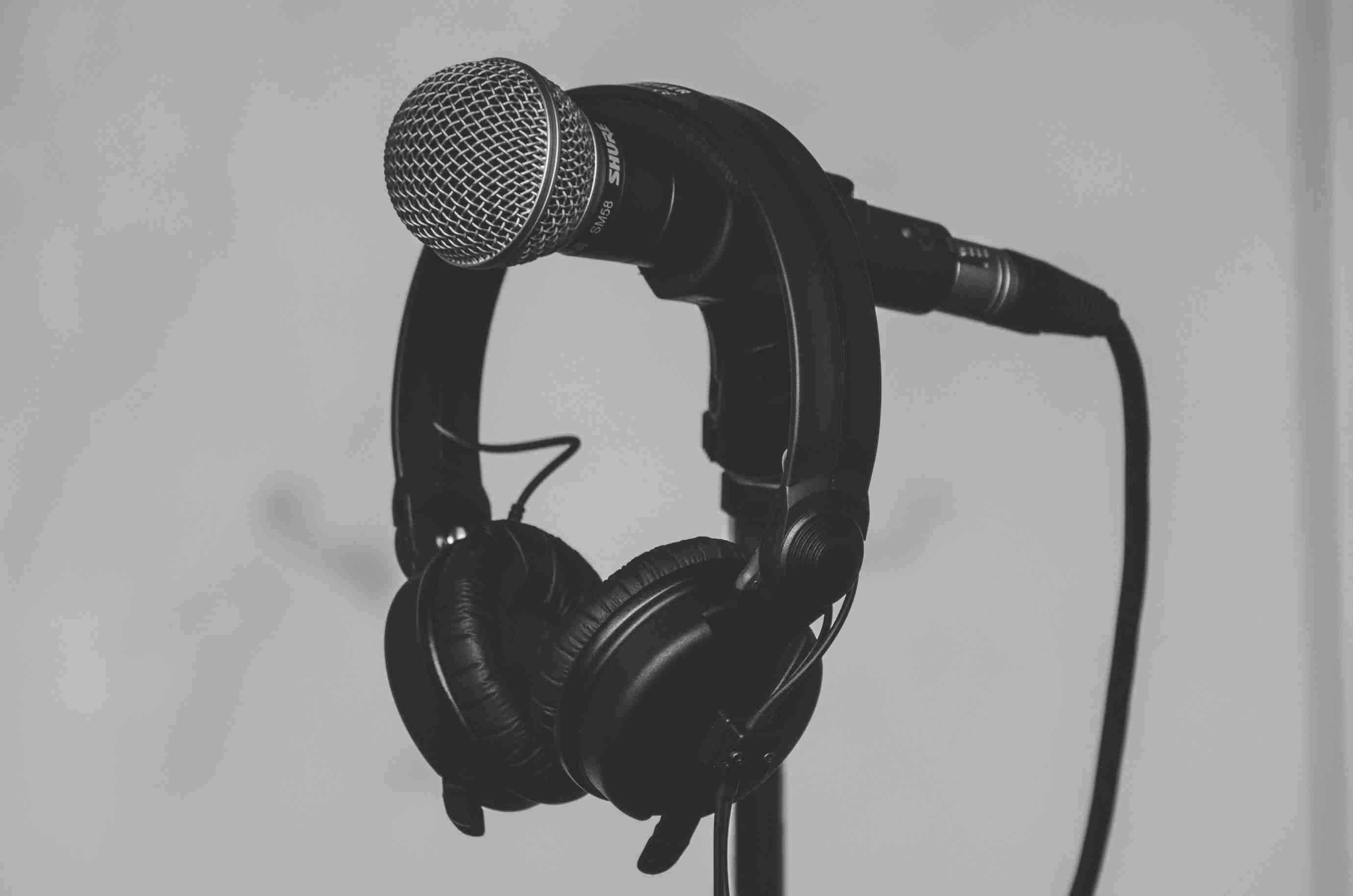 Close-up of a professional microphone and headphones on a stand