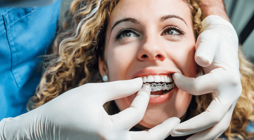 Woman smiling, about to wear teeth retainers