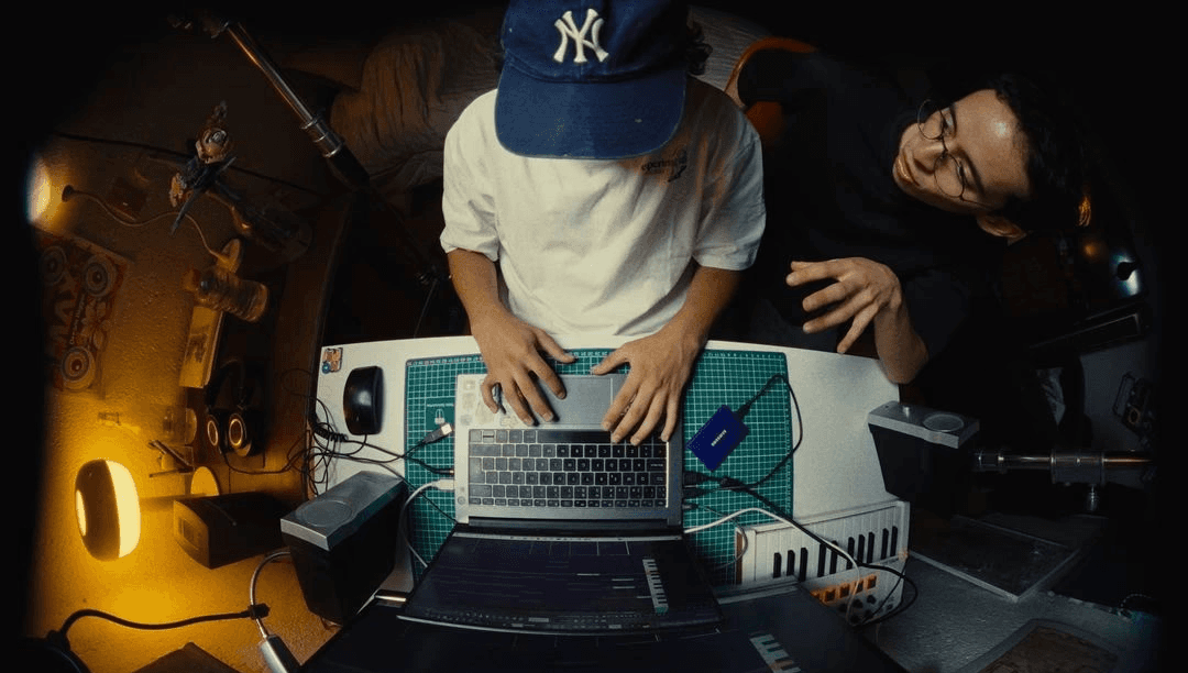 musician on laptop in studio