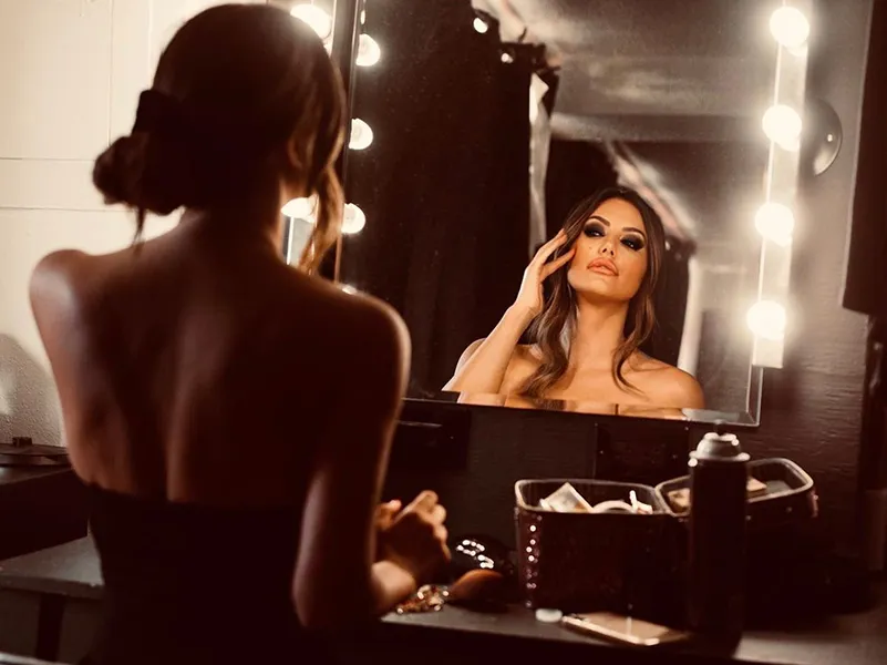 a woman holding a red flower