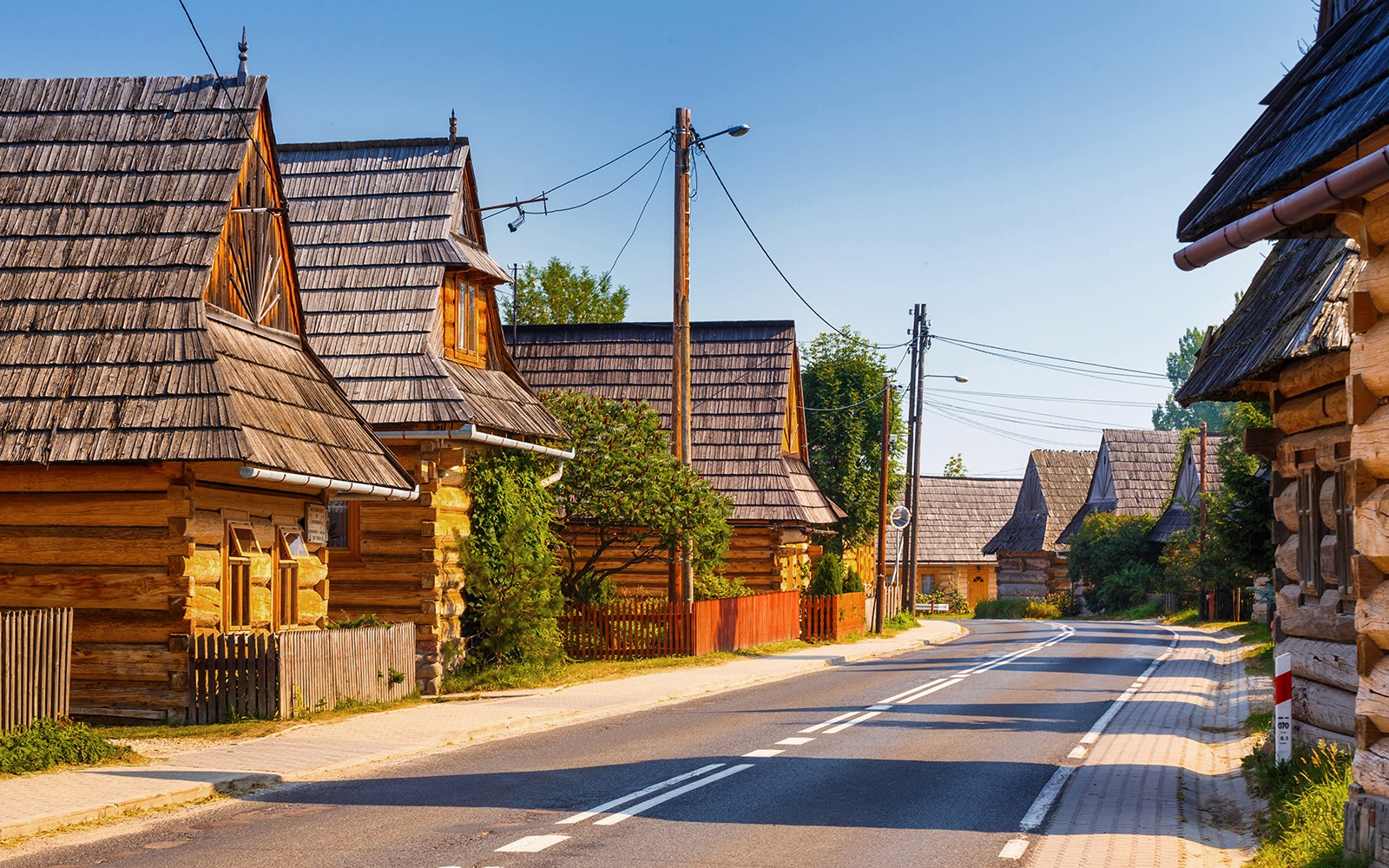Traditional wooden houses in Zakopane, Poland, along a quiet street.