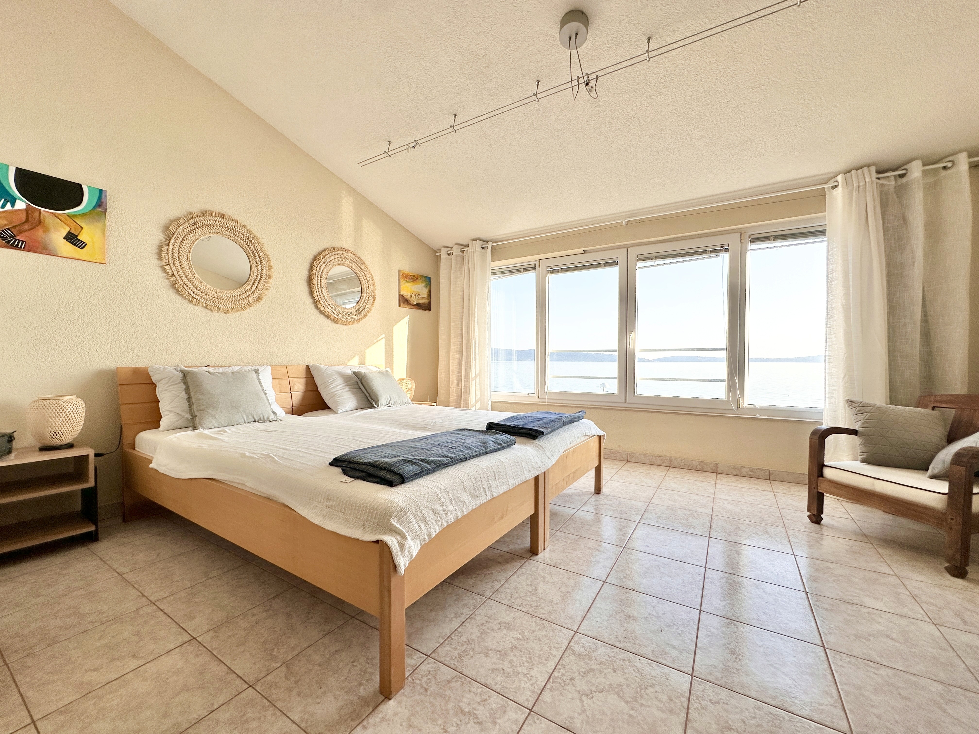 Black sports car in front of a modern, futuristic curved building.