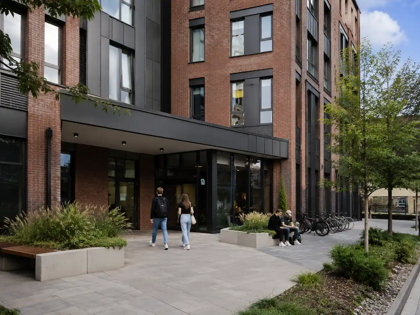 High quality student accommodation building in Europe with happy students walkin into the building