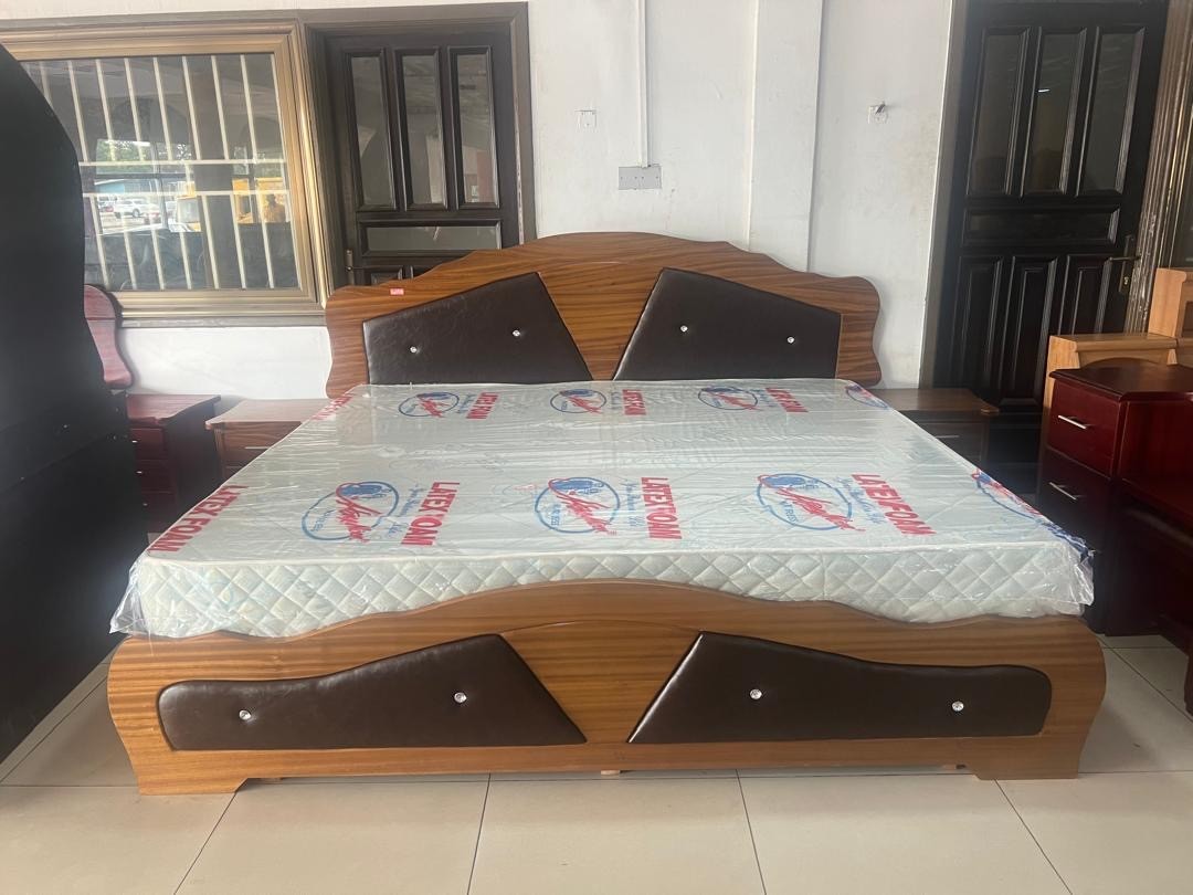 a gray couch with a wooden base on a gray background