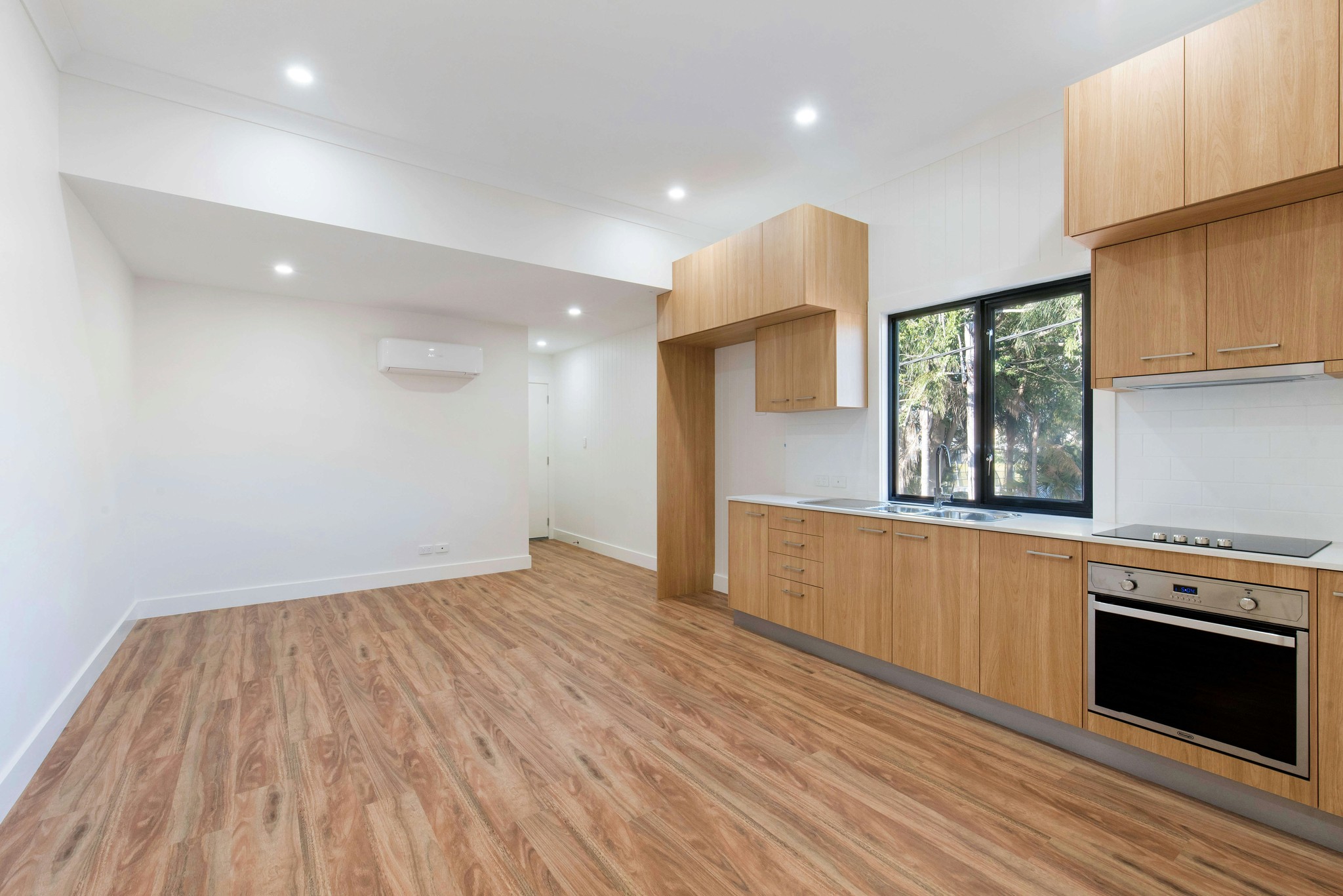 A modern indoor ceiling with recessed LED downlights.