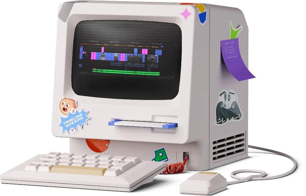 Retro-style personal computer with stickers on the monitor and side. The computer is off-white with a matching keyboard and mouse.
