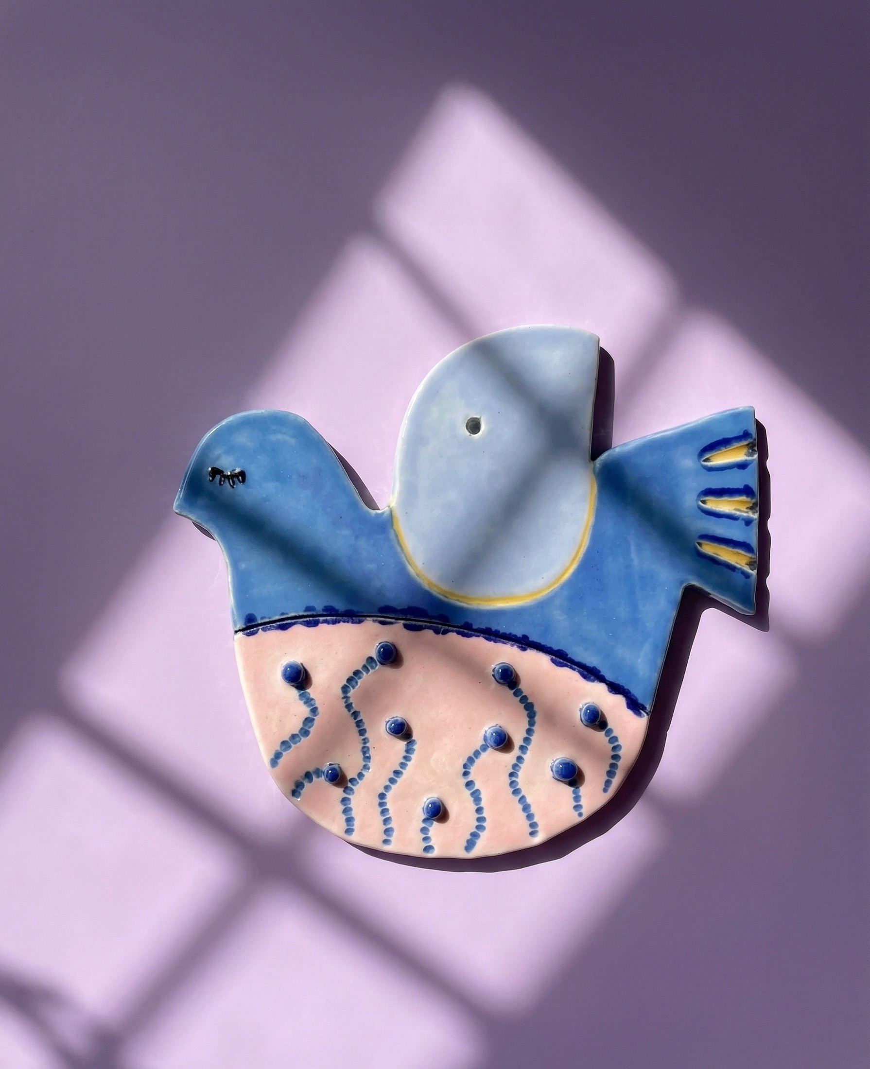 a ceramic decoration shaped like a bird