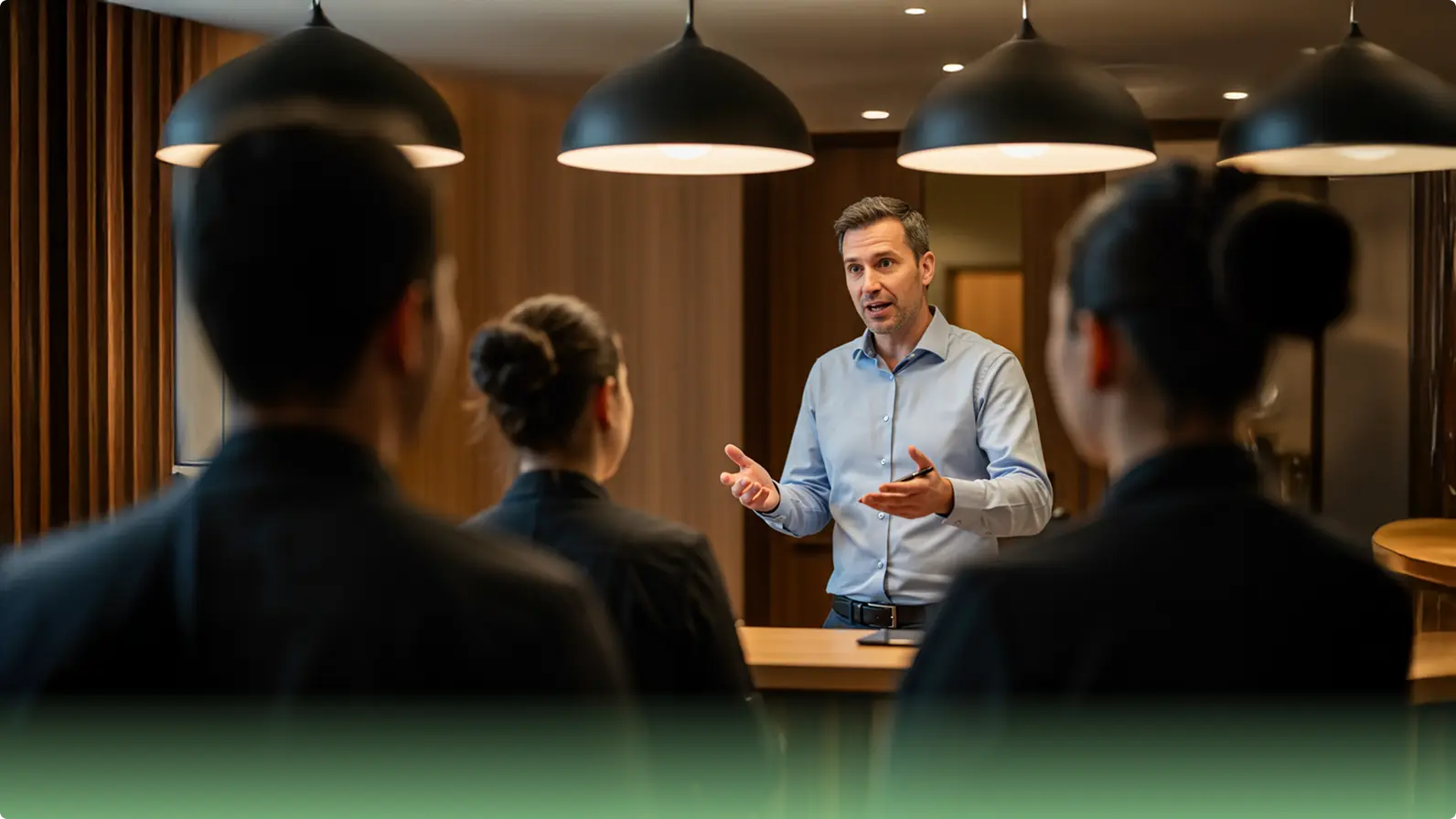 Hotelier Speaking with Staff